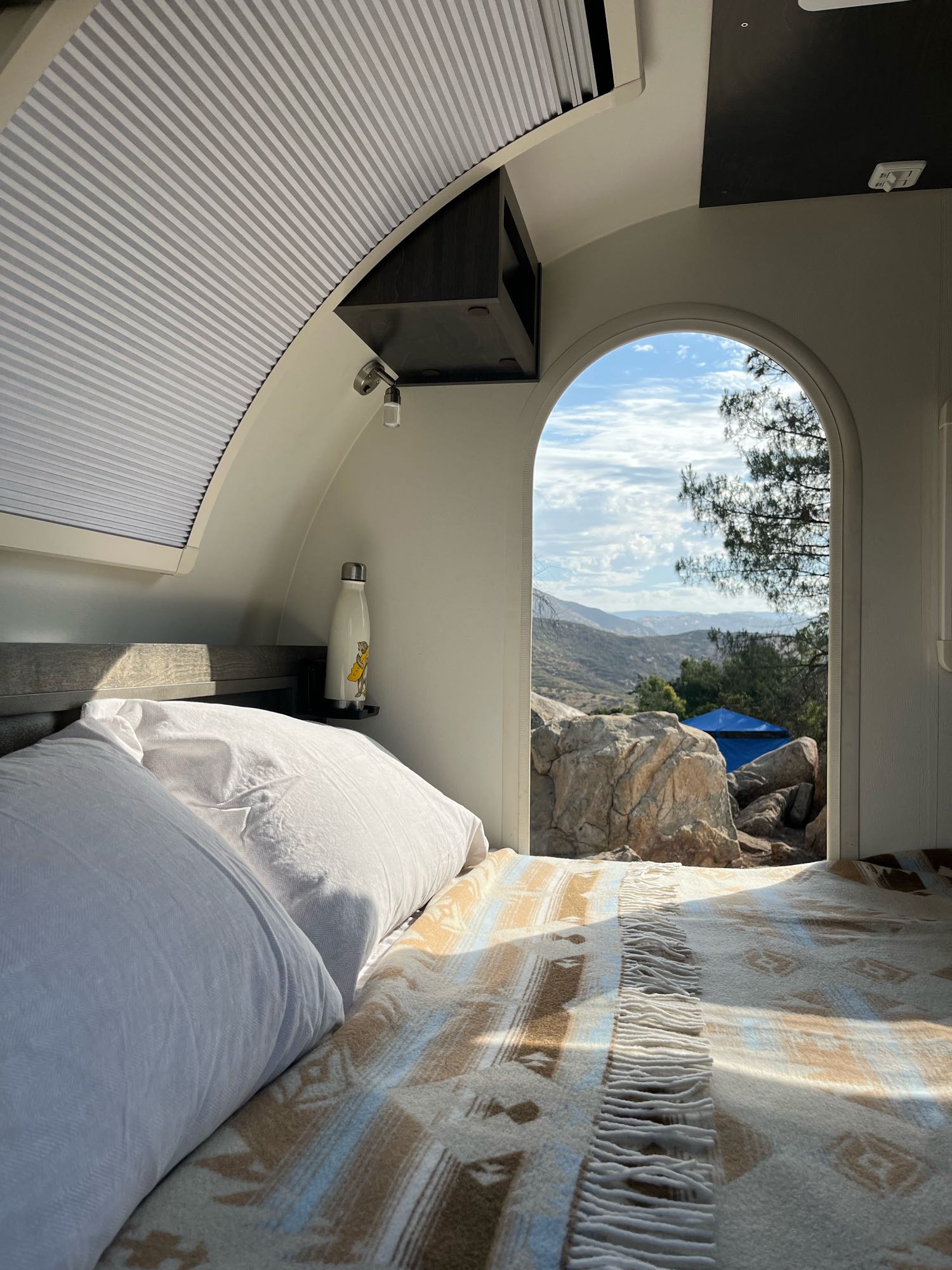 Queen-sized bed with doors on each side of camper. This gives two campers their own door for easy access in and out of the camper.. NuCamp T@g Boondock 2021