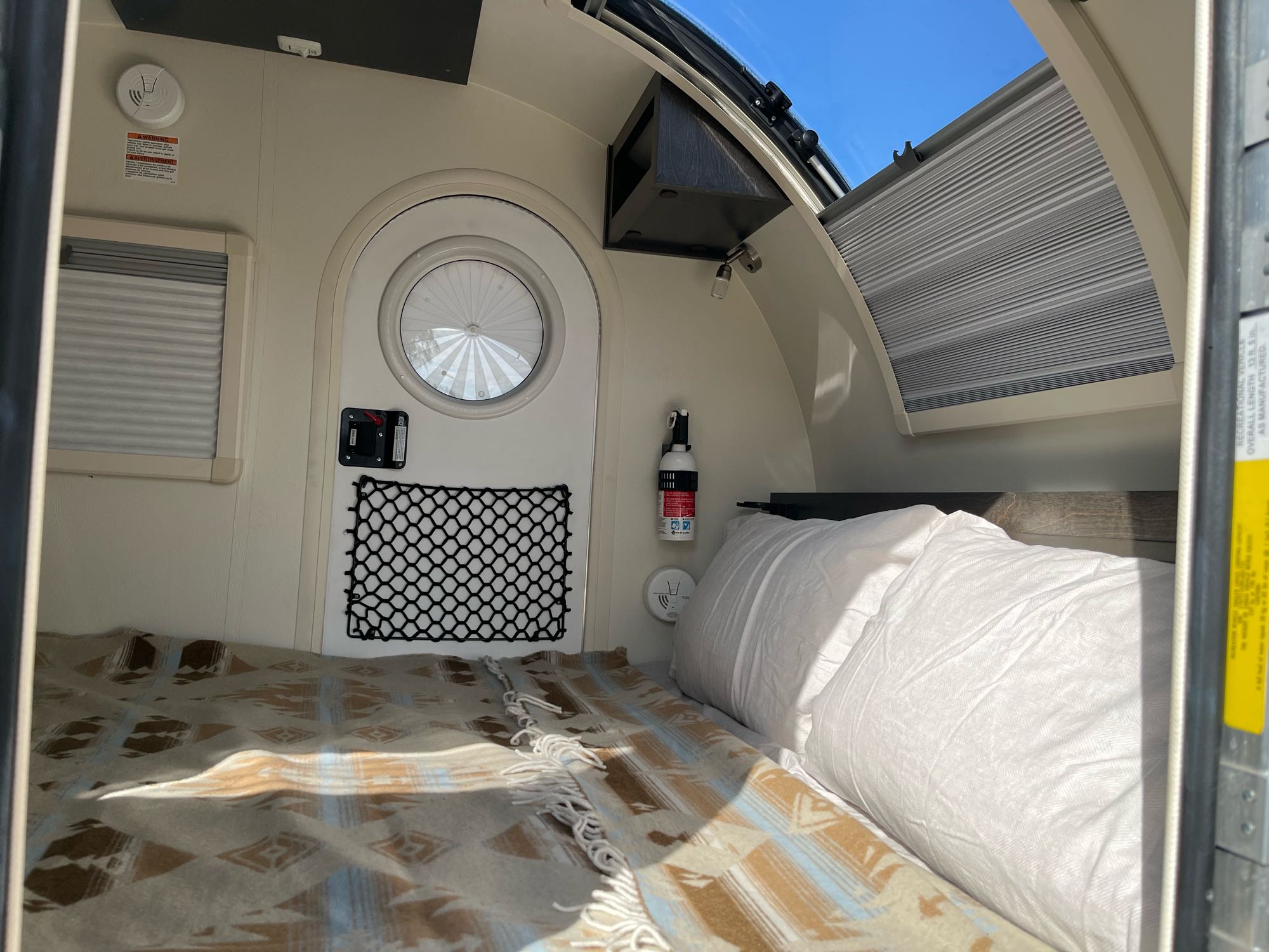 The Stargazer window above the bed offers great night views of the stars and natural light during the day. Or, close the blinds for a cozy interior.. NuCamp T@g Boondock 2021