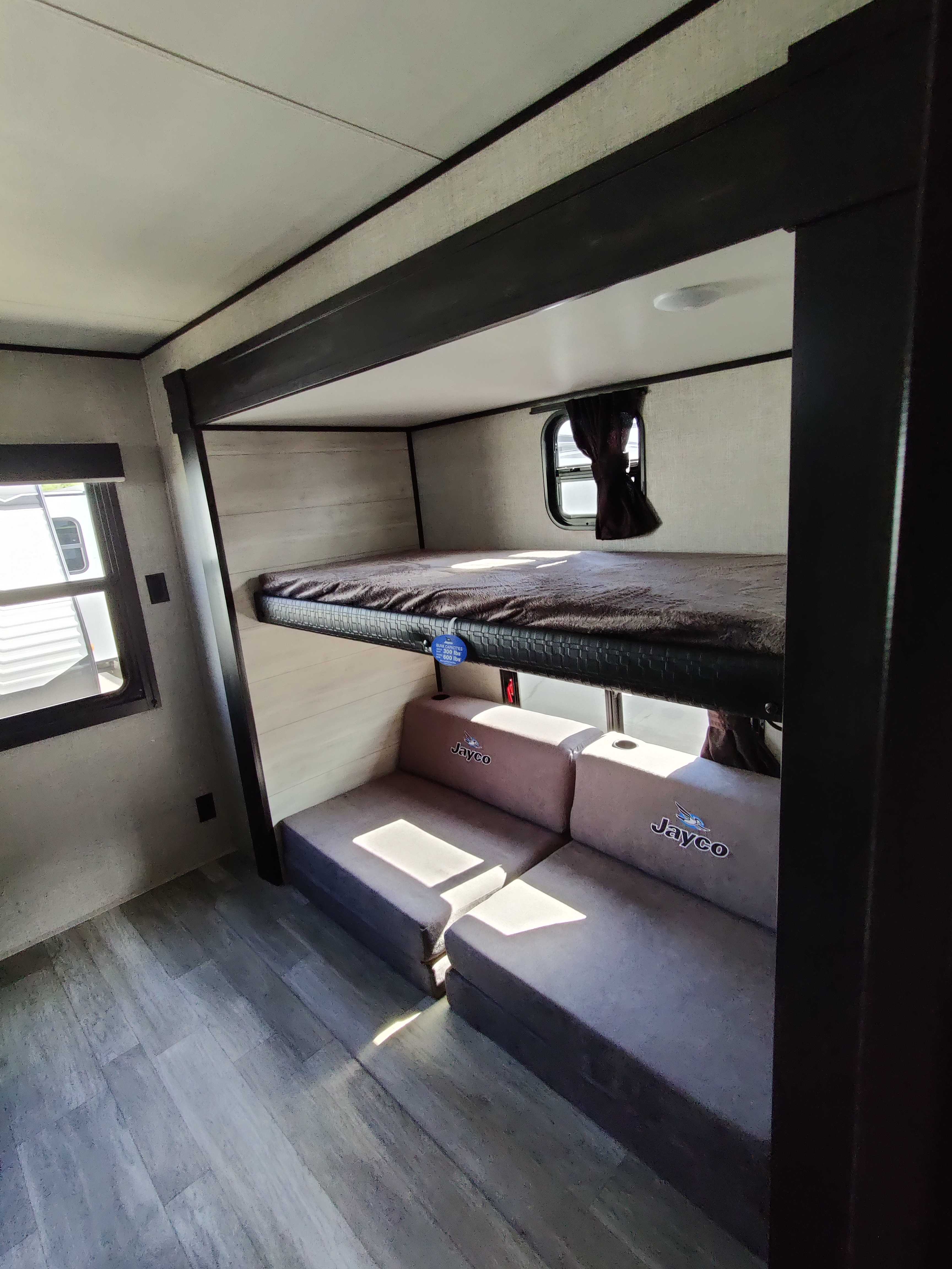 Cozy Jayco RV rental interior with bunk beds and convertible seating, perfect for families on the go.. Jayco Jay Flight 32BHDS 2022