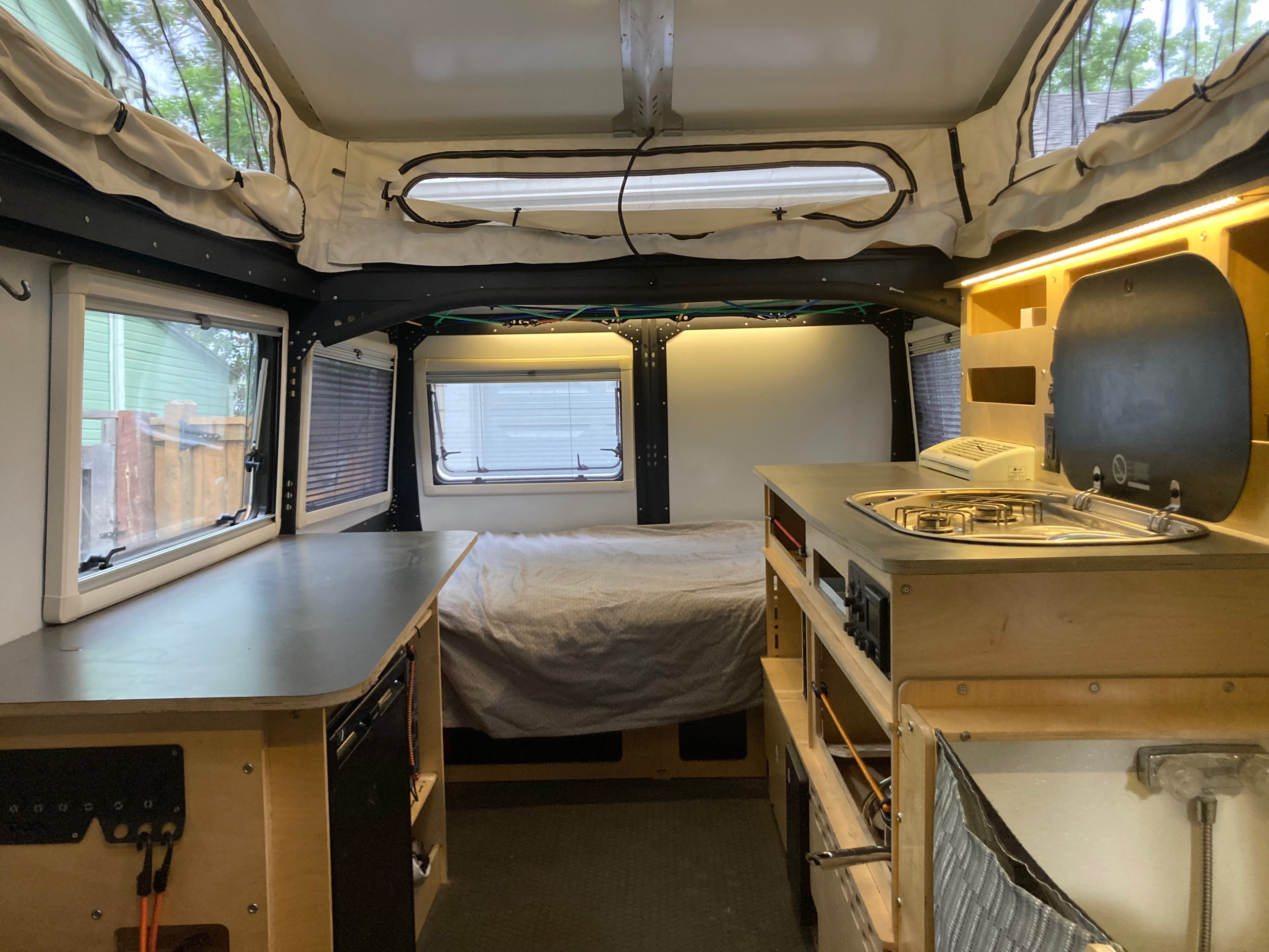 You can see the sleeping area, kitchen area, and general purpose storage and dining table. . TAXA TAXA Trailer 2019