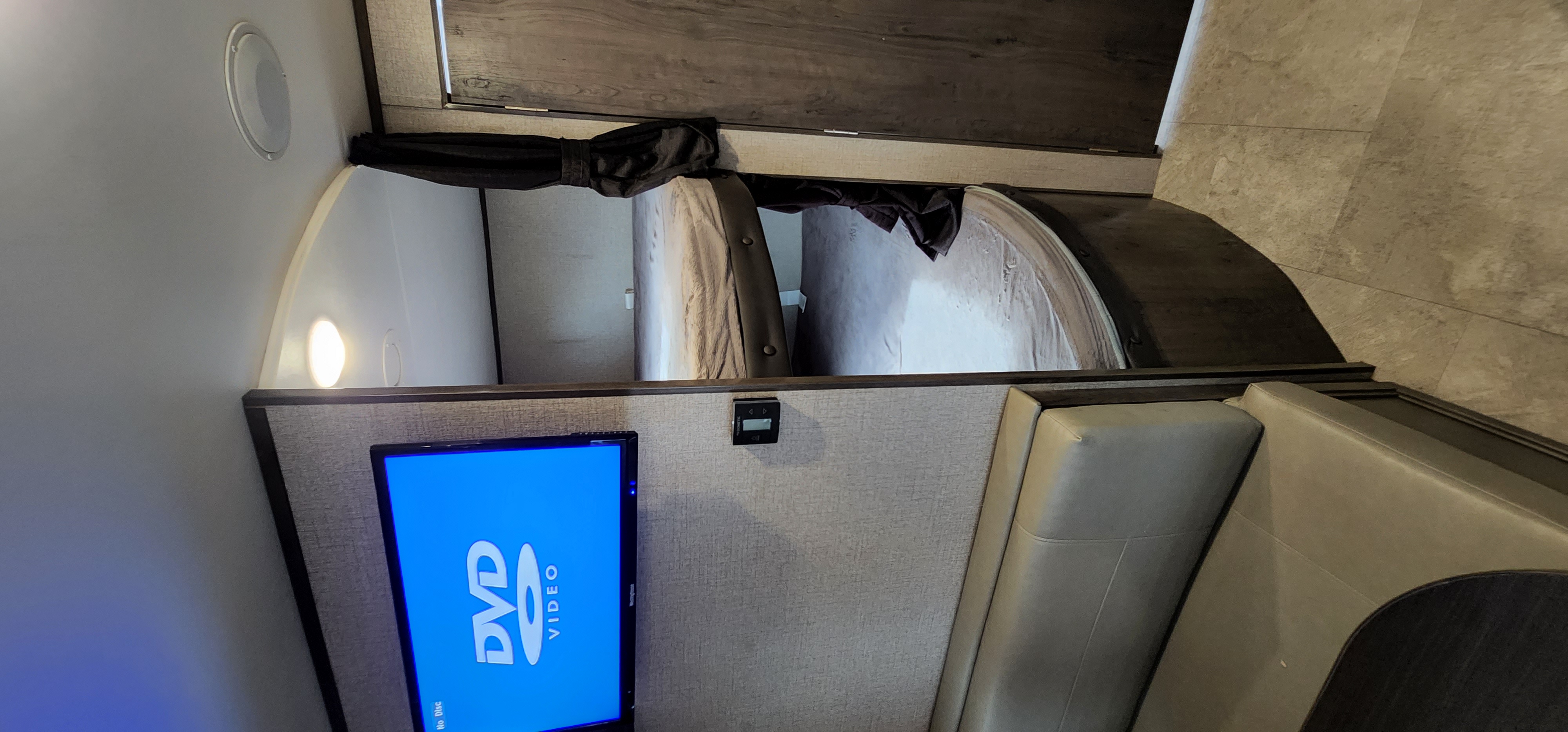 Cozy RV rental interior with bunk beds, a TV, and dinette seating. Ready for family road trips.. Jayco Jay Flight SLX 2020