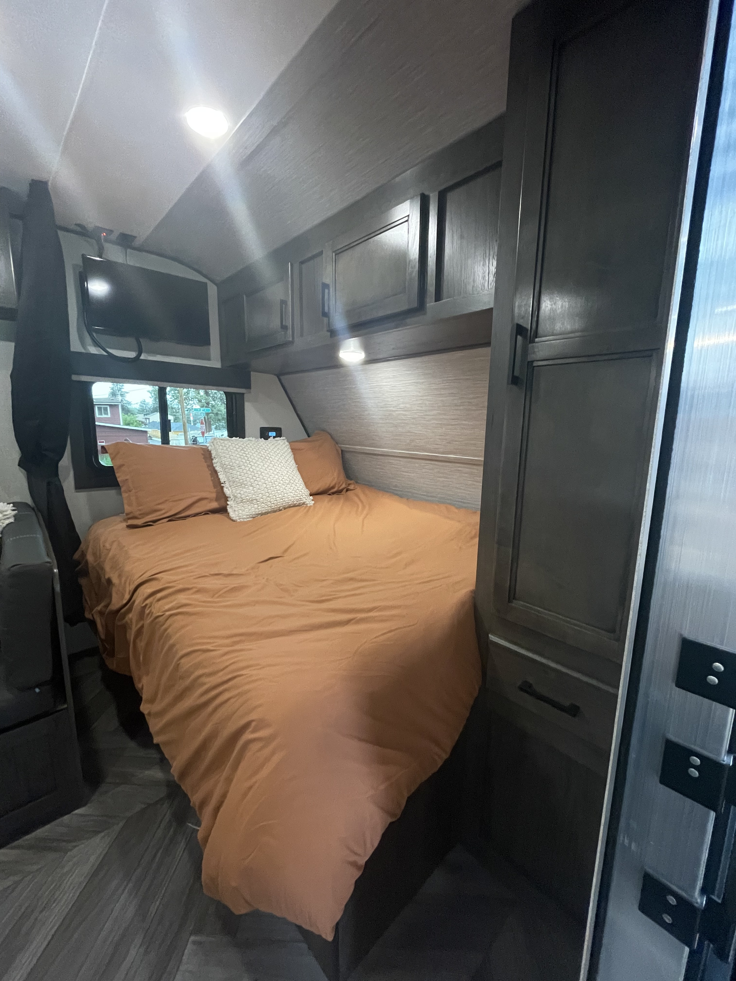 Queen bed with curtain for privacy. Highland Ridge RV Olympia Sport 2022