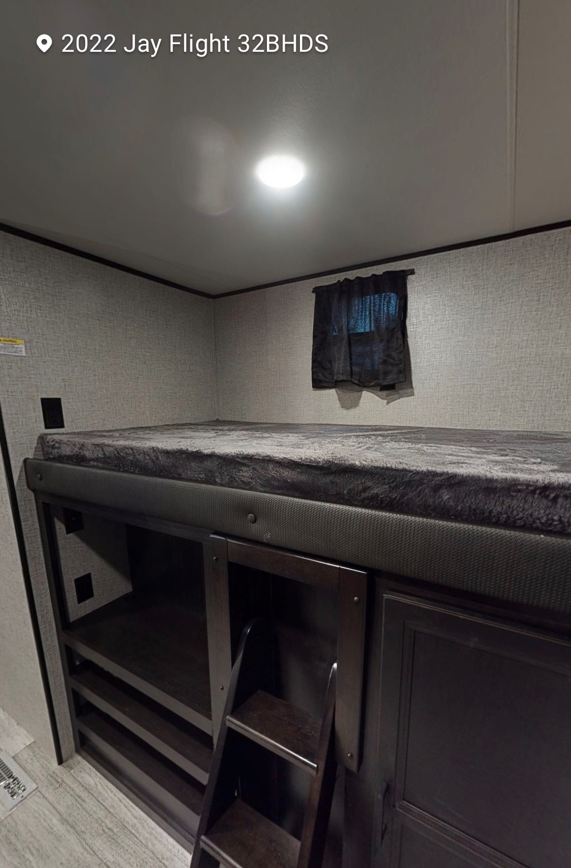 RV rental: Interior view of a comfortable bunk bed with soft grey bedding, access ladder, and built-in storage.. Jayco Jay Flight 2022