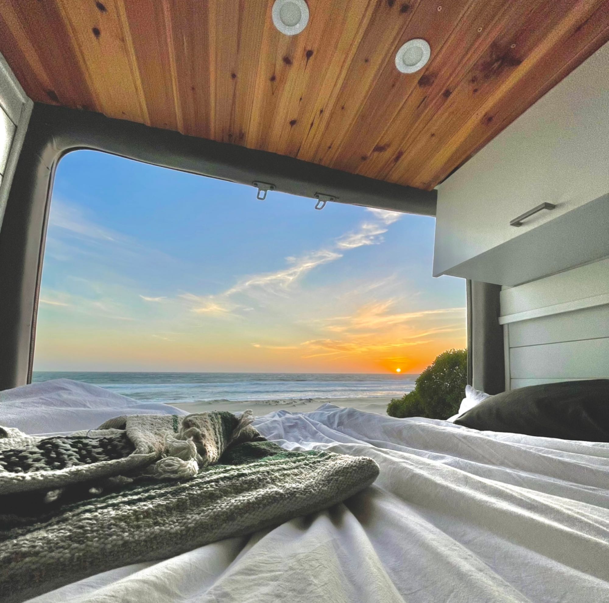 Enjoy the stunning beach sunset from your comfortable RV rental bed. Perfect for a relaxing van life adventure!. Other MBZ Sprinter 4x4 (144 WB) 2020