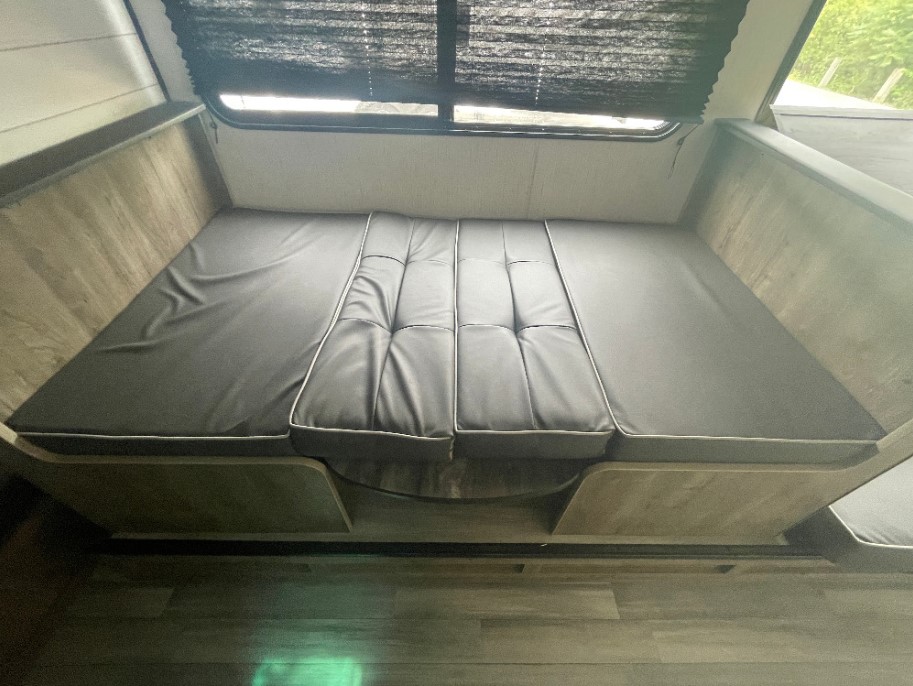 RV rental: Dinette with dark gray cushions converts to a bed. Ready for your cozy travel adventures.. Heartland RVs Pioneer Trail Blazer 2022