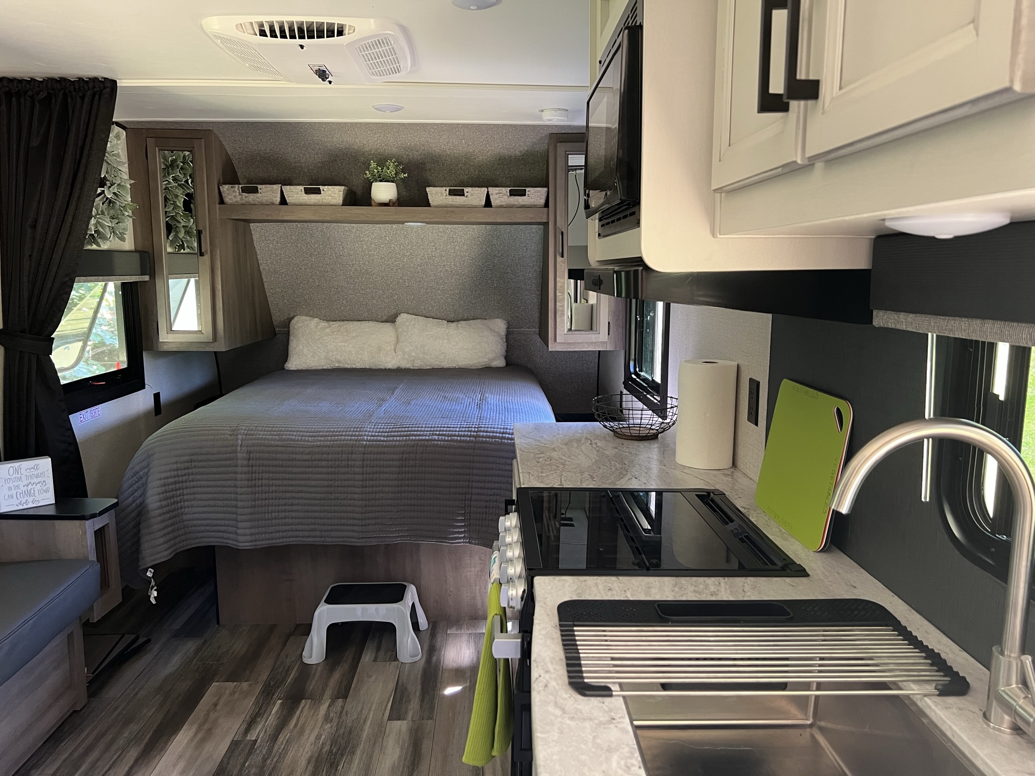 Step into this modern RV rental! A cozy interior with a well-appointed kitchen, comfortable bed, and storage awaits your travel.. Highland Ridge RV Open Range 2022