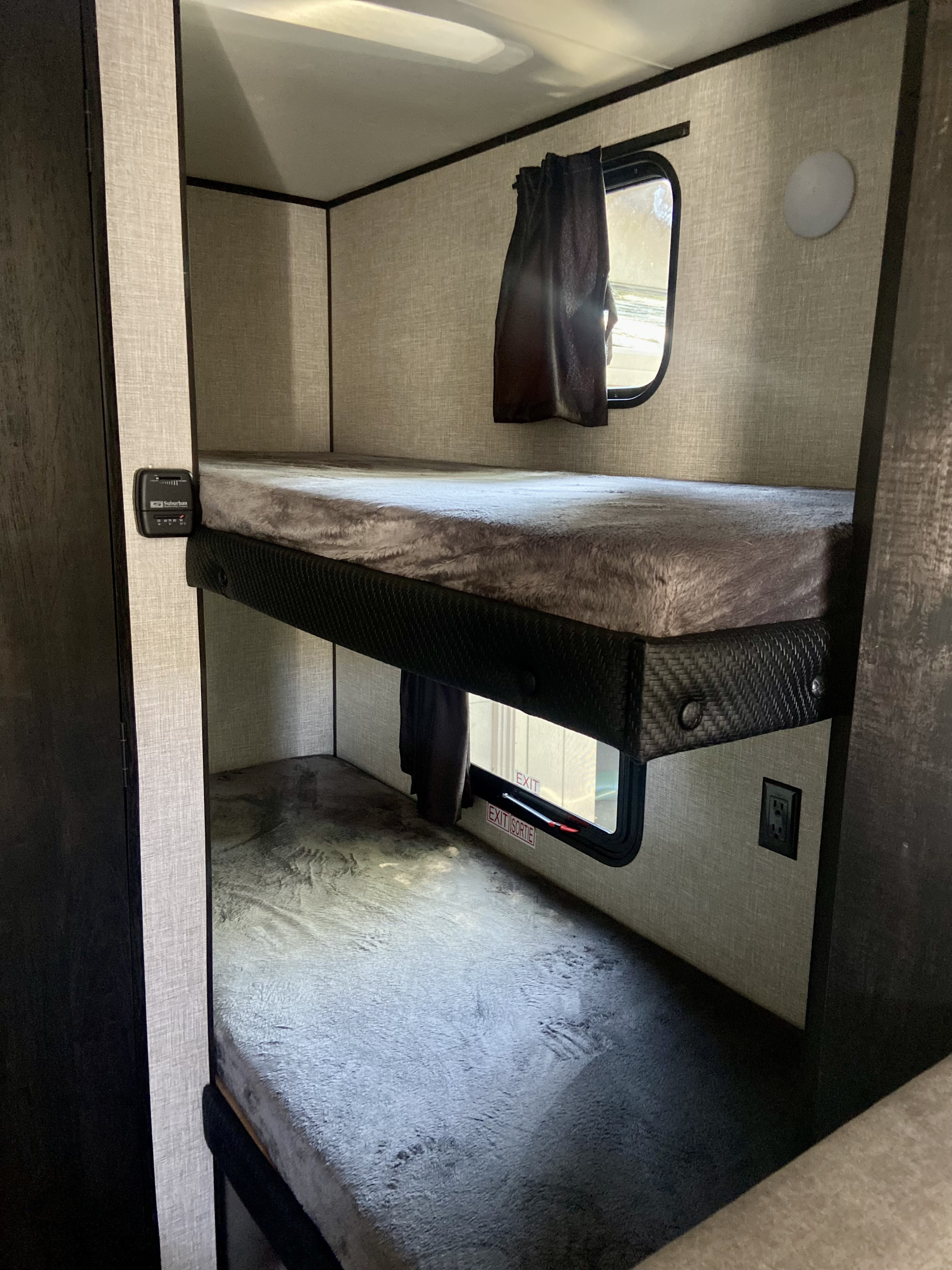 This RV rental features stacked bunk beds, complete with cozy bedding, windows, a thermostat, and power outlets.. Jayco Jay Flight Baja 2022