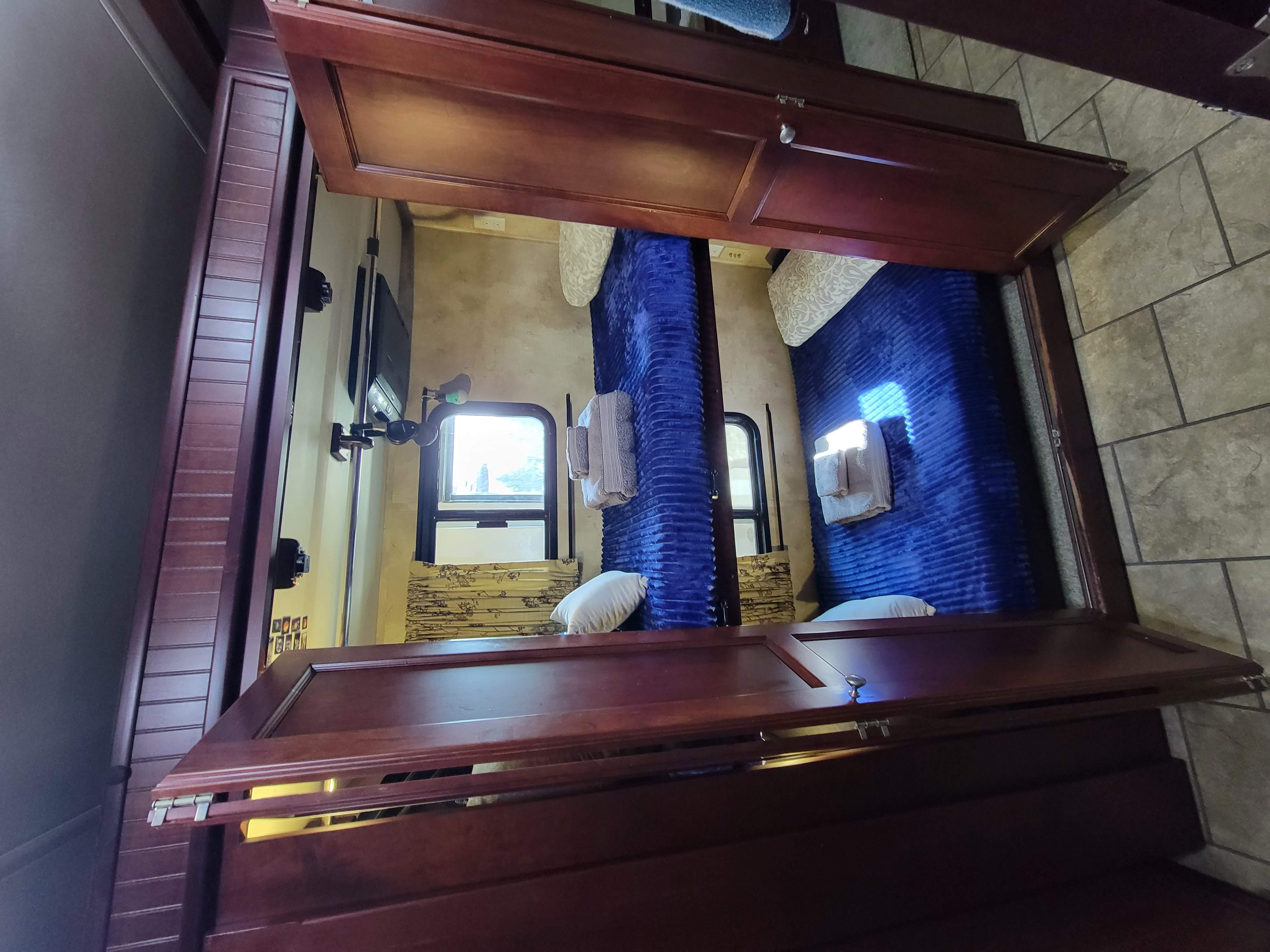 RV rental bunk room: Two sleeping berths with windows, a TV, and wood cabinetry.. Allegro Allegro Red 2011