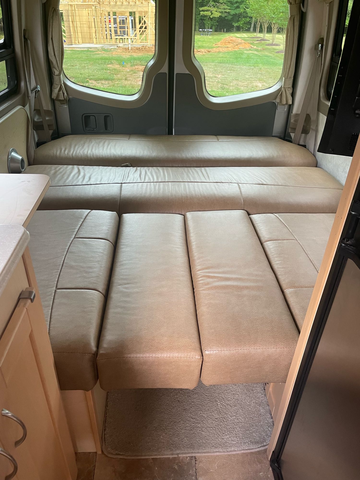 RV rental interior: Tufted cushions create a comfortable, spacious bed. Enjoy scenic views for your road trip adventure!. Pleasure-Way Pleasure-Way Class B 2012