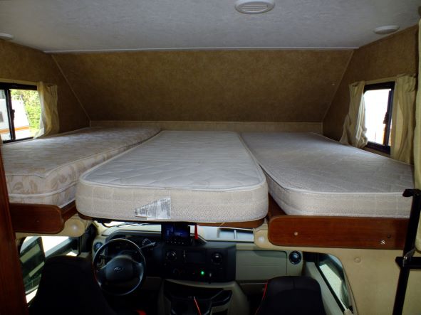 This RV rental features a cozy cabover bunk with three comfortable beds, ideal for extra sleeping space.. Forest River Sunseeker 2015