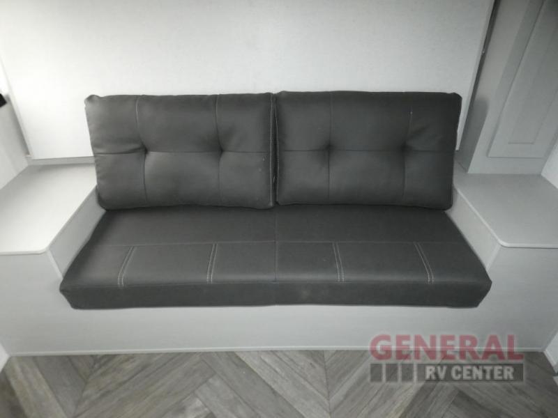 Enjoy comfortable RV rental travel with this dark upholstered dinette/sofa, featuring modern RV interior design.. Forest River Wildwood FSX Platinum 2021