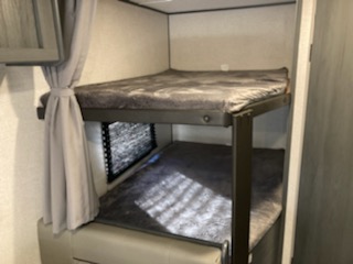 Inside your RV rental: cozy bunk beds with comfy mattresses, offering a practical sleeping space for your next trip.. Dutchmen Other 2022