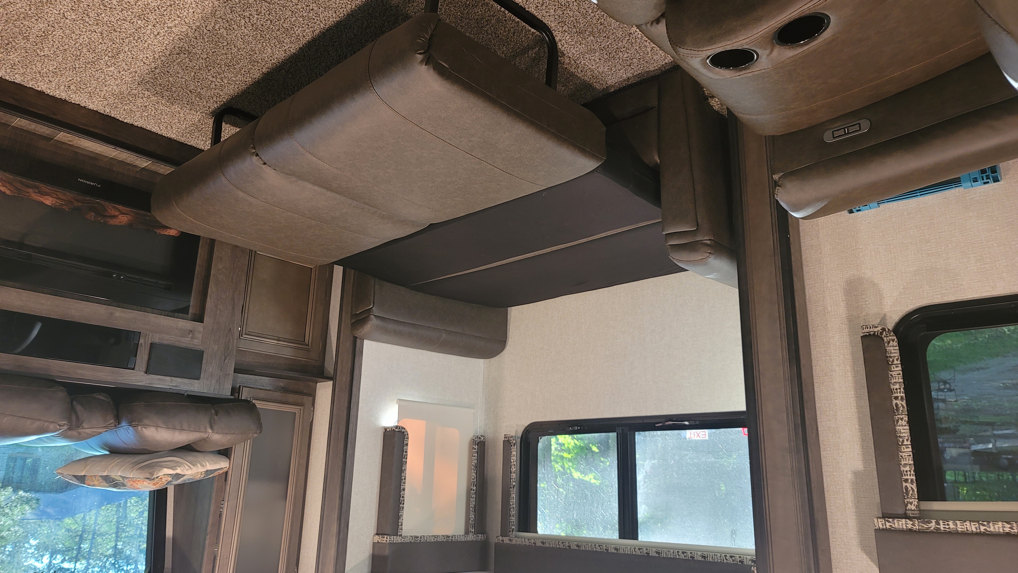 Step inside this cozy rv rental! Features a comfortable reclining sofa with cupholders, fireplace, and scenic windows.. Keystone RV Montana High Country 2019