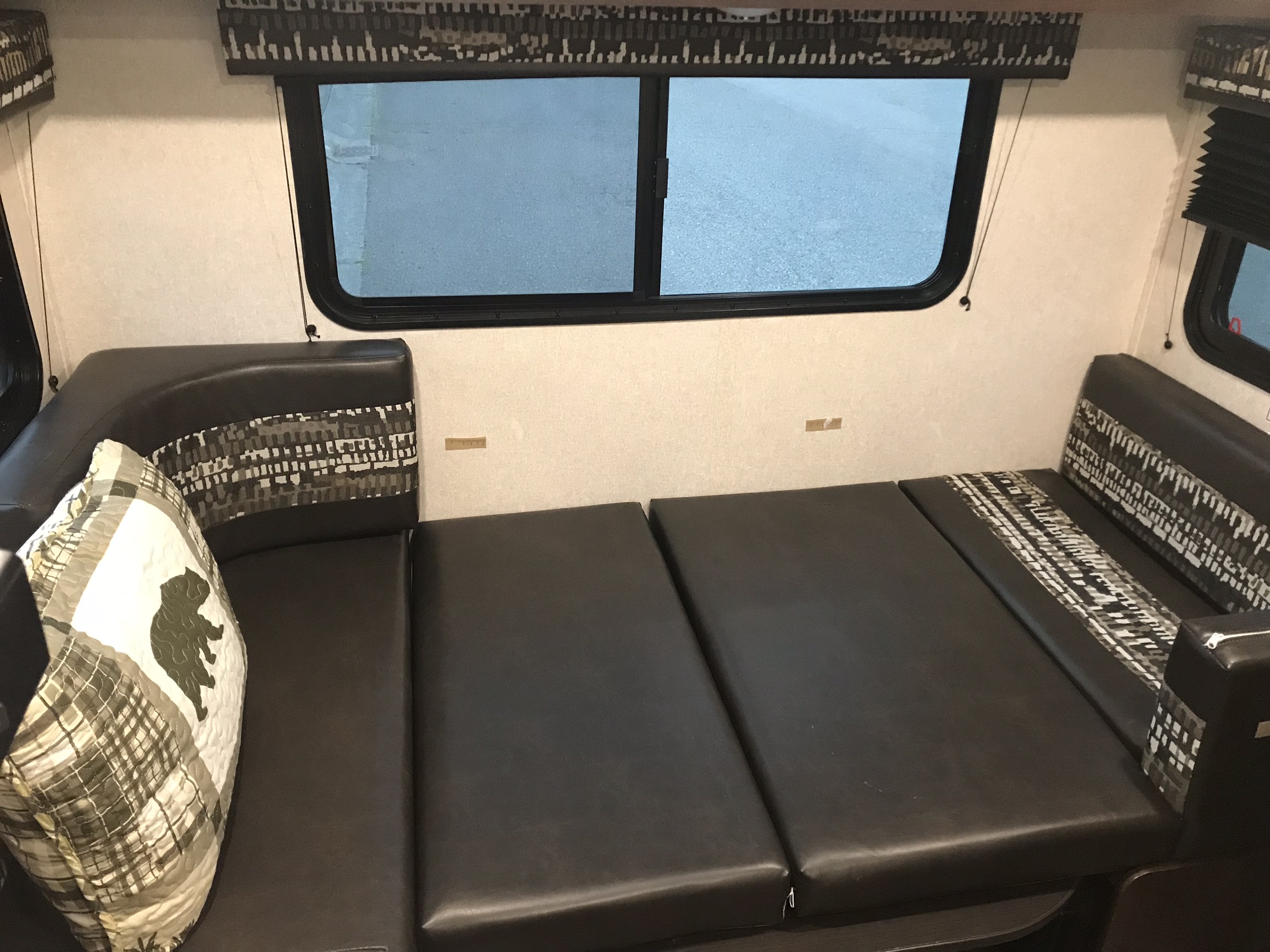 RV rental: Convertible dinette bed with dark faux leather cushions, patterned fabric, and bear pillow. Ready for sleep or seating.. Jayco Jay Flight SLX Baja Edition 2018