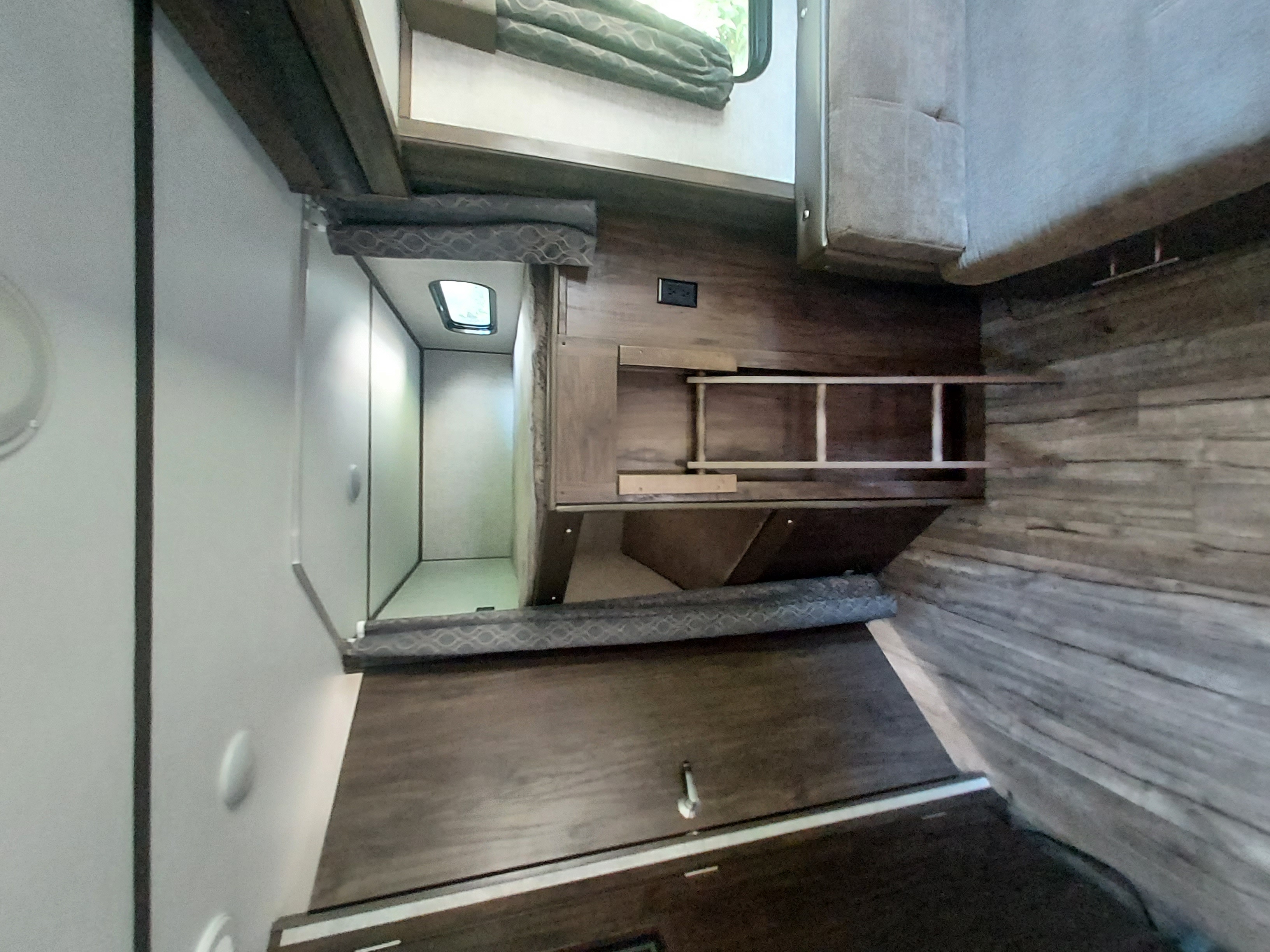 RV rental interior: Bunk beds with access ladder and ample storage, perfect for travel comfort.. Forest River Cherokee Alpha Wolf 2019