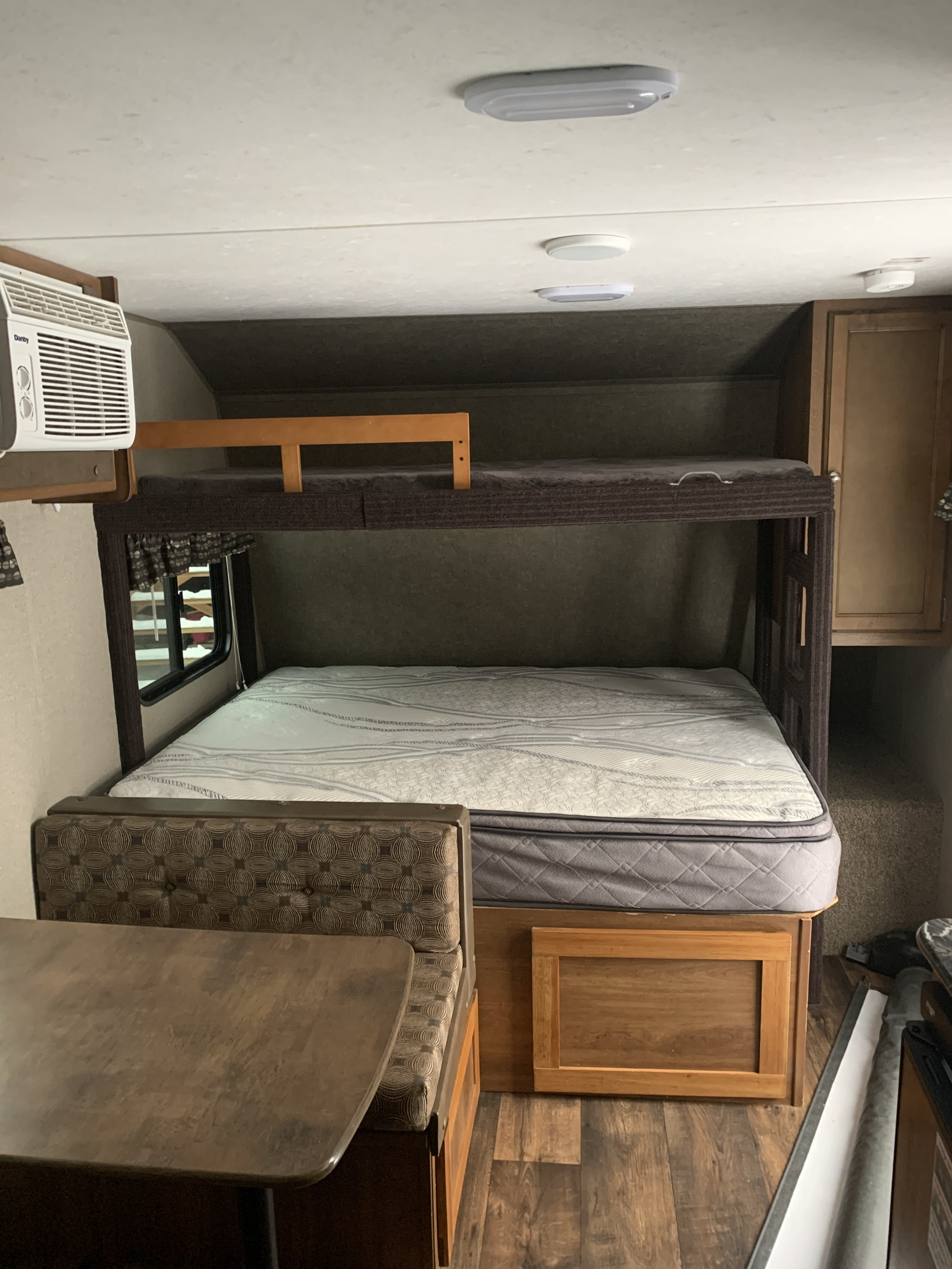 Cozy RV rental interior with a comfy mattress on the lower bunk bed, a dinette, and an AC unit for your travel adventures.. Springdale Summit 2017