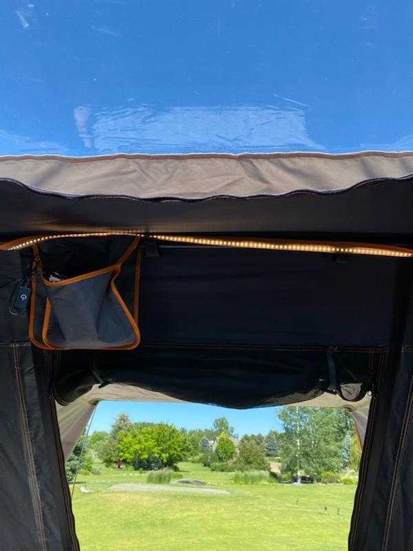 Inside an rv rental, LED lights illuminate a storage pouch with a view of a green landscape and trees.. Other Other 2021