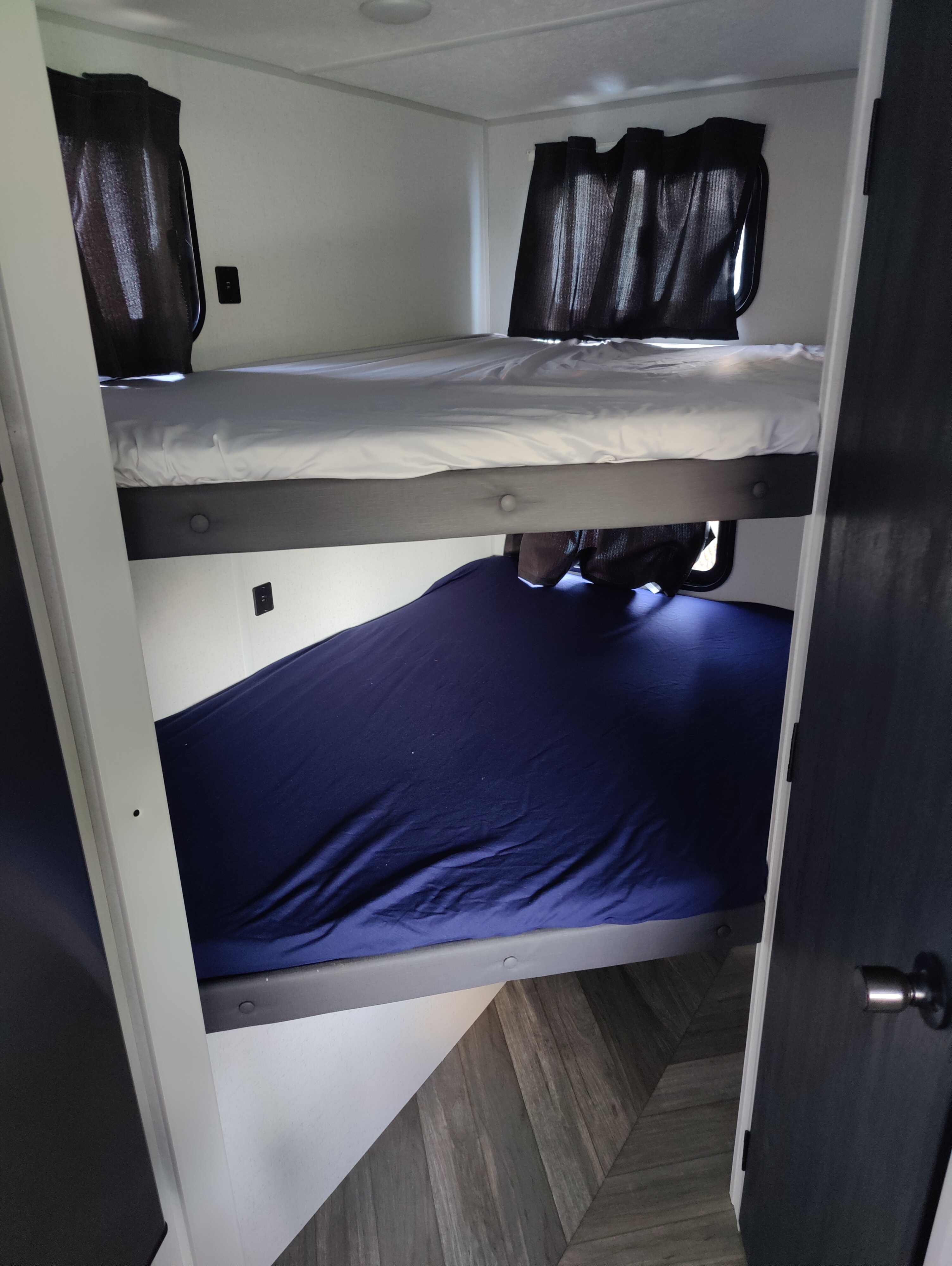 Cozy bunk beds in this RV rental offer comfortable sleeping with individual windows & power outlets.. Forest River Salem FSX 2022