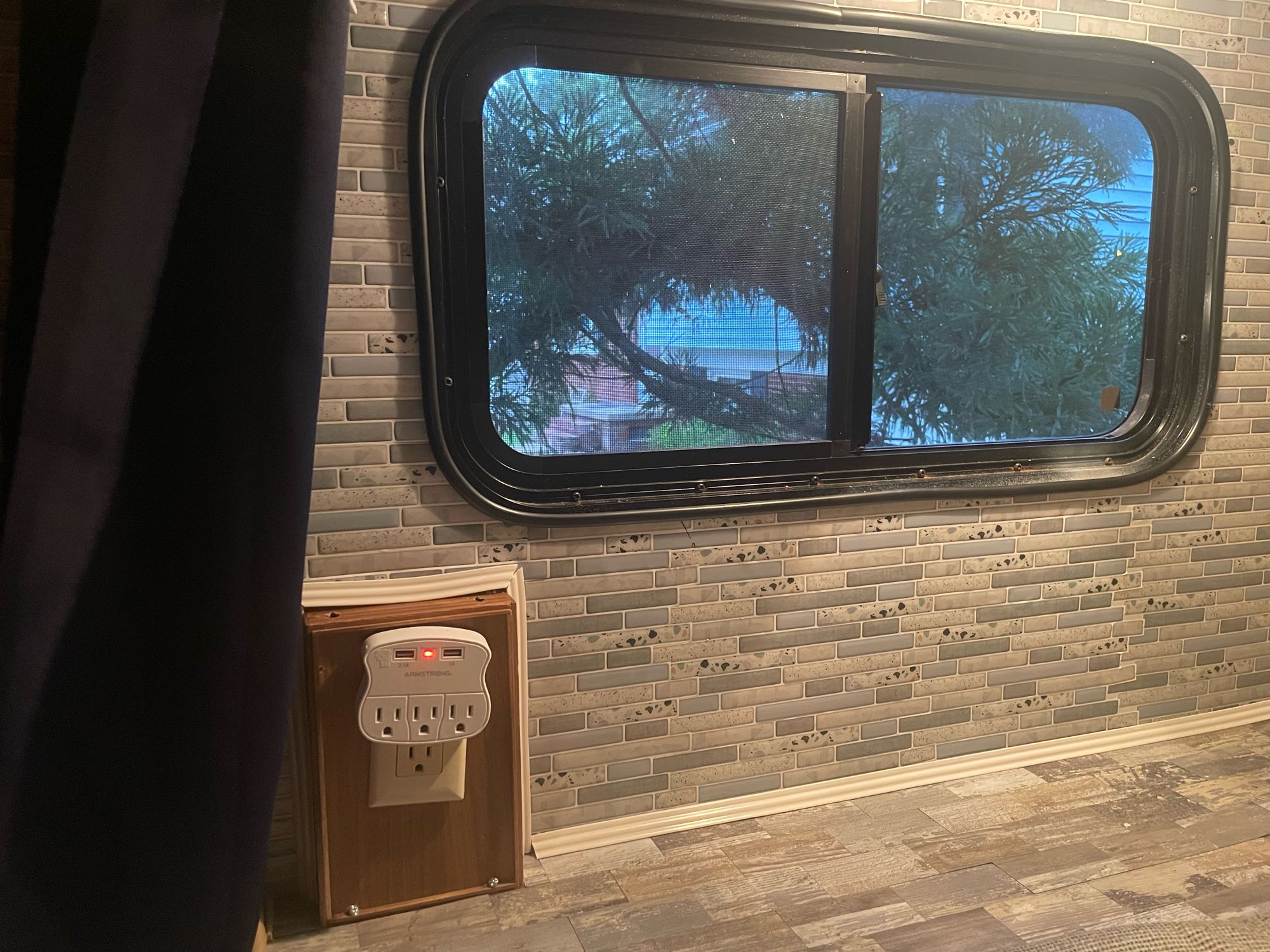 RV rental interior with window view, modern tile backsplash, and convenient multi-outlet for charging.. Forester LE 2012