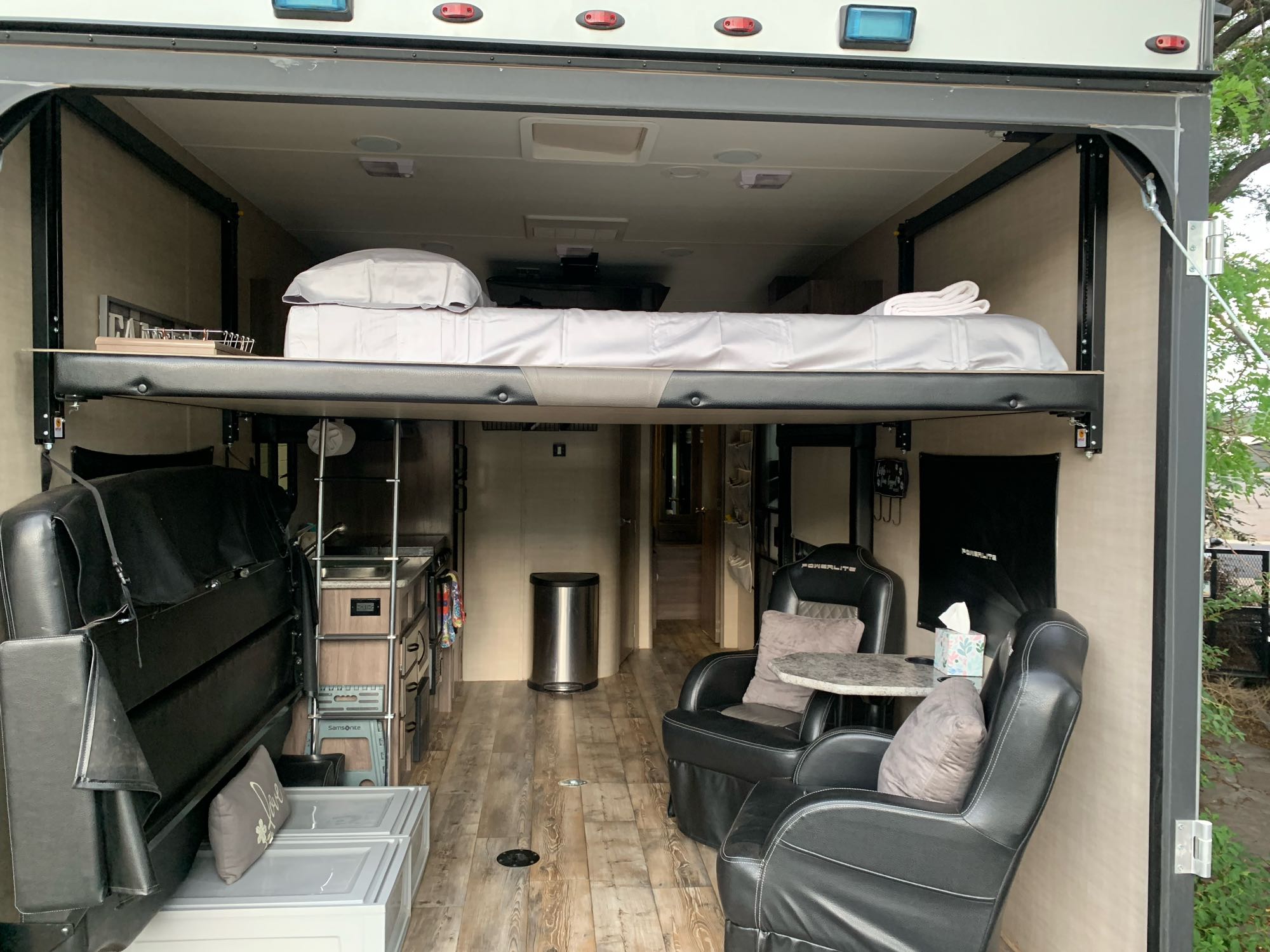 RV rental's spacious interior: suspended bed, recliners, and kitchen provide a comfortable travel living space.. Pacific Coachworks Blaze'N 2017
