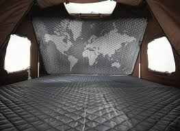 Experience comfort in an RV rental! This pop-up tent interior shows a quilted bed and a world map back panel, ideal for camping adventures.. Toyota 4Runner 2018