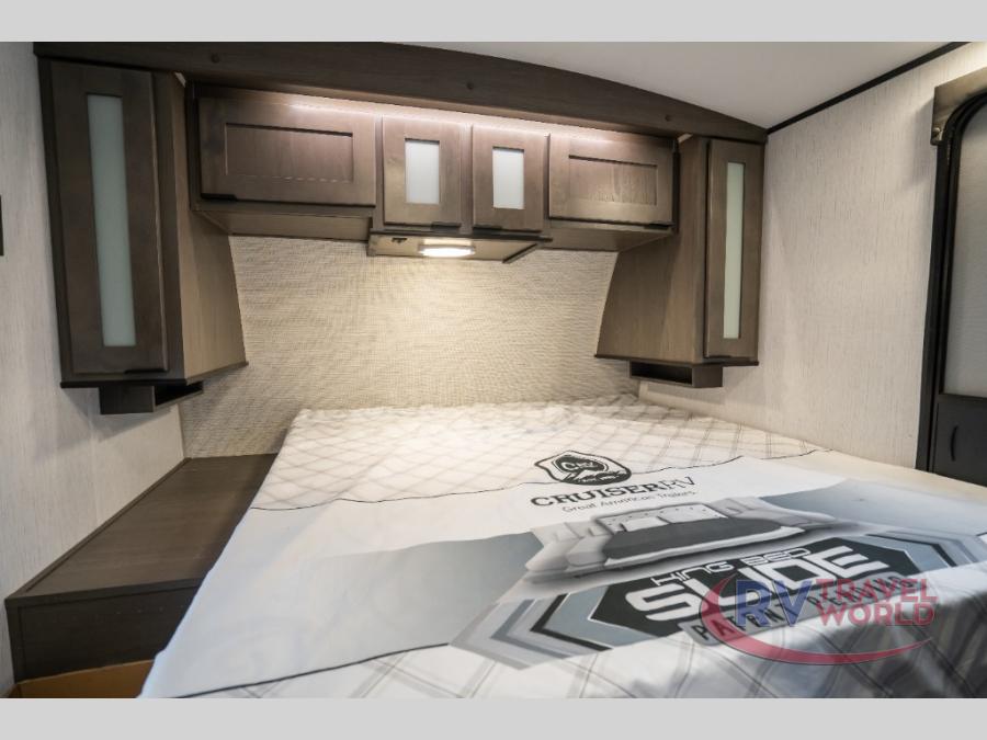 Cozy RV rental bedroom with modern overhead cabinets, task lighting, a comfortable bed, and convenient bedside storage.. Cruiser RV MPG Ultra Lite 2022