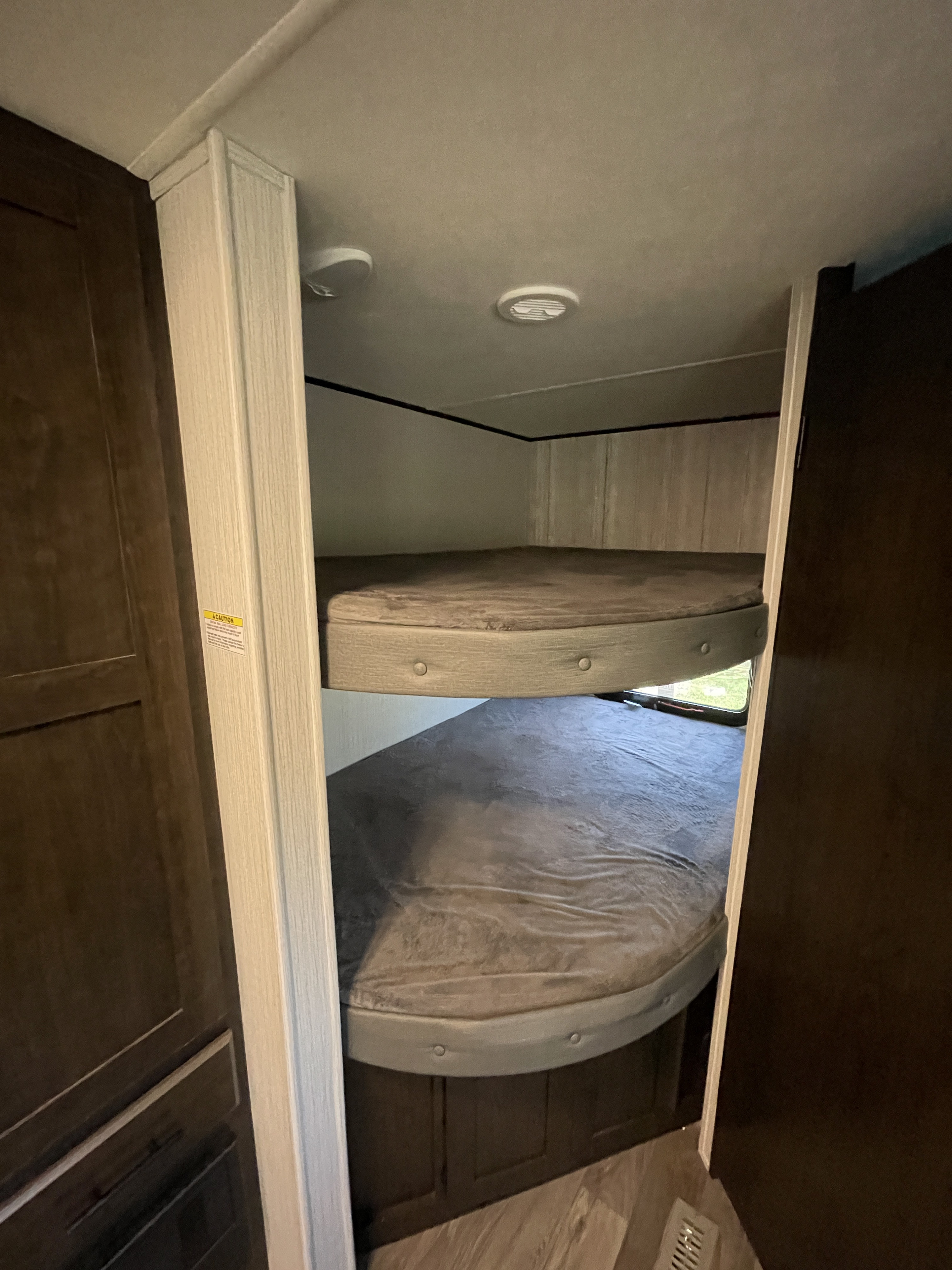 Cozy RV rental interior featuring comfortable bunk beds for extra sleeping space in your camper or travel trailer.. Heartland RVs Pioneer 2021