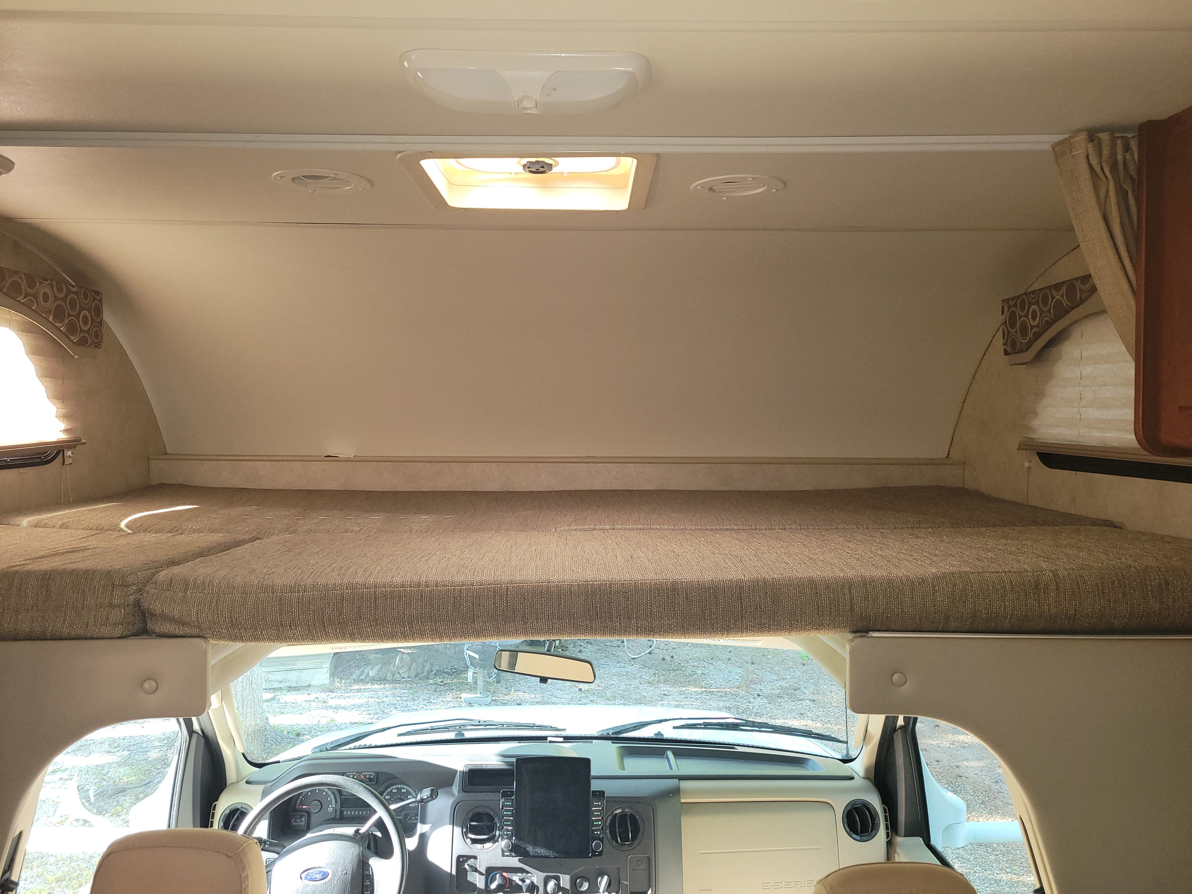 View inside an RV rental showing the large cab-over bunk bed positioned above the driver's area.. Thor Chateau 2012