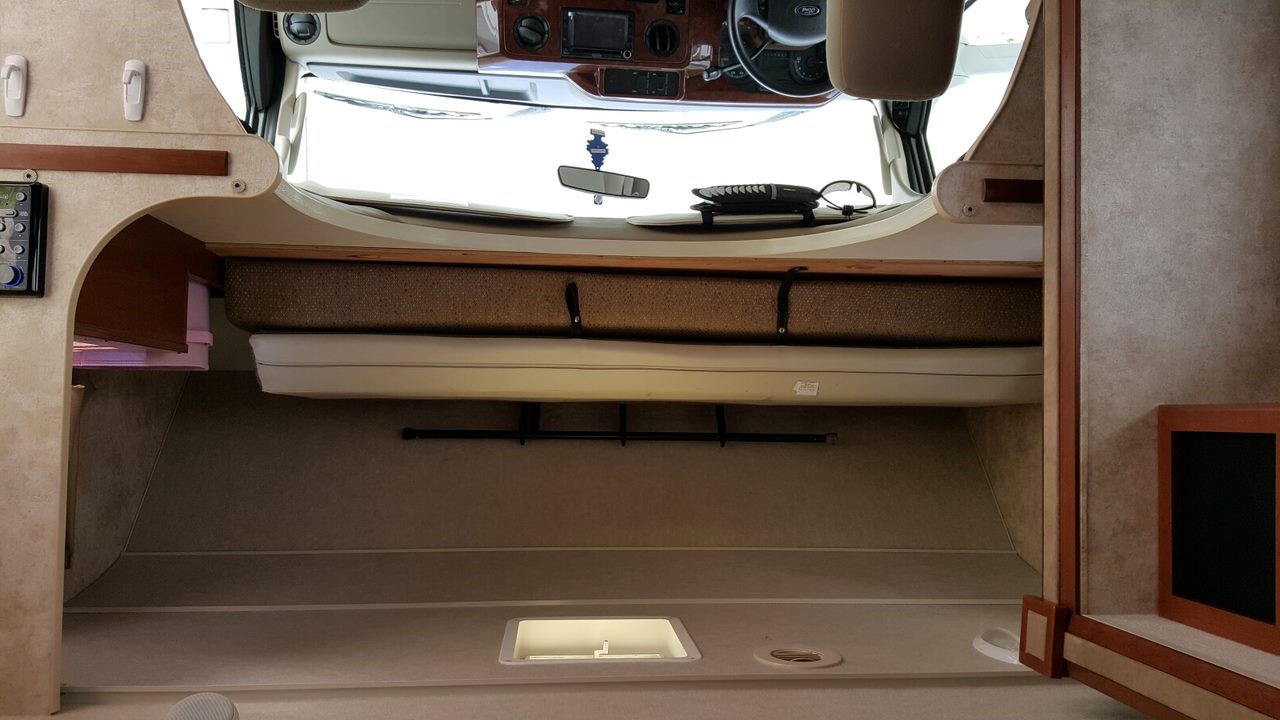 RV rental: Inside view of the motorhome's cab-over bed, driver's cockpit, and main living space.. Winnebago Chalet 2013