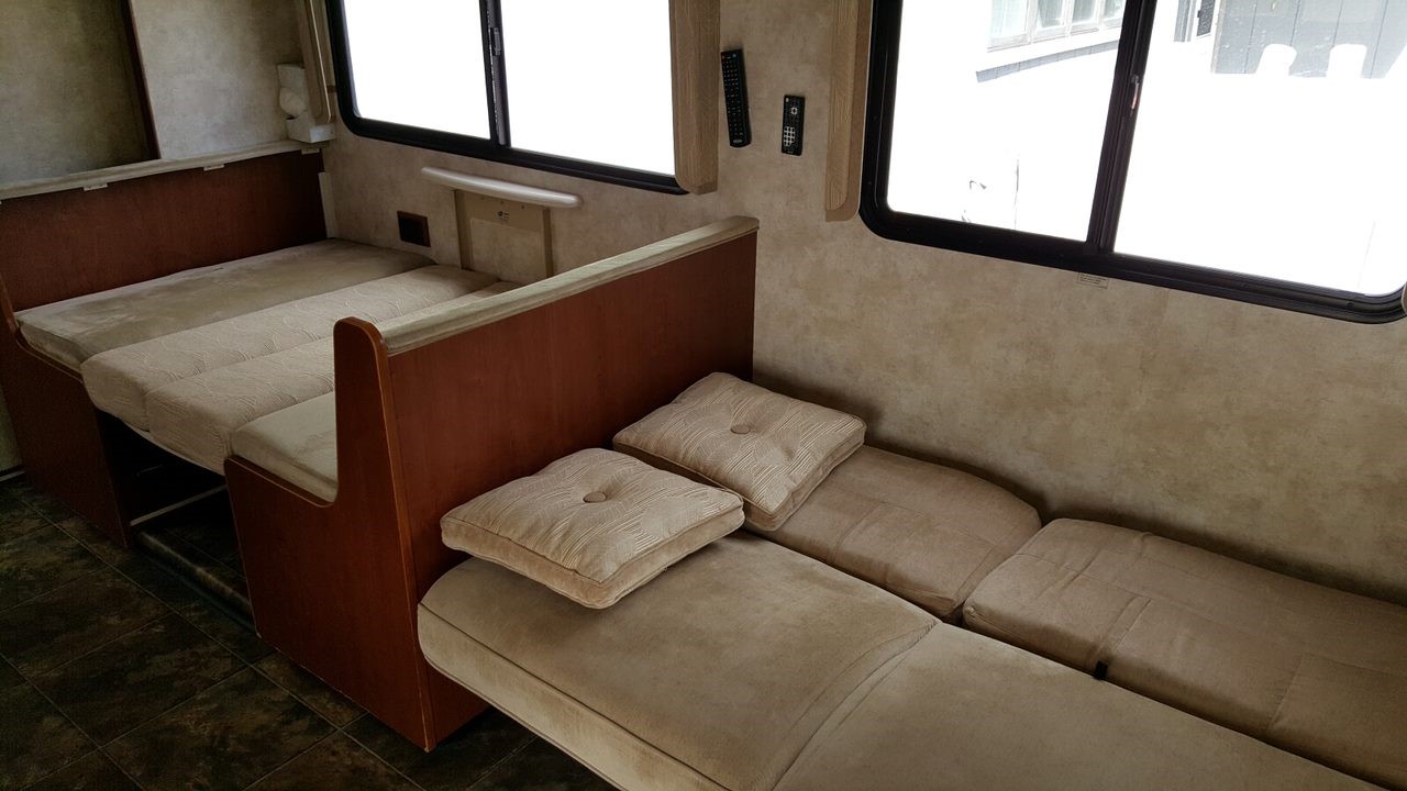 This RV rental features a versatile dinette that converts to a bed, plus a long bench seat for comfortable travel.. Winnebago Chalet 2013