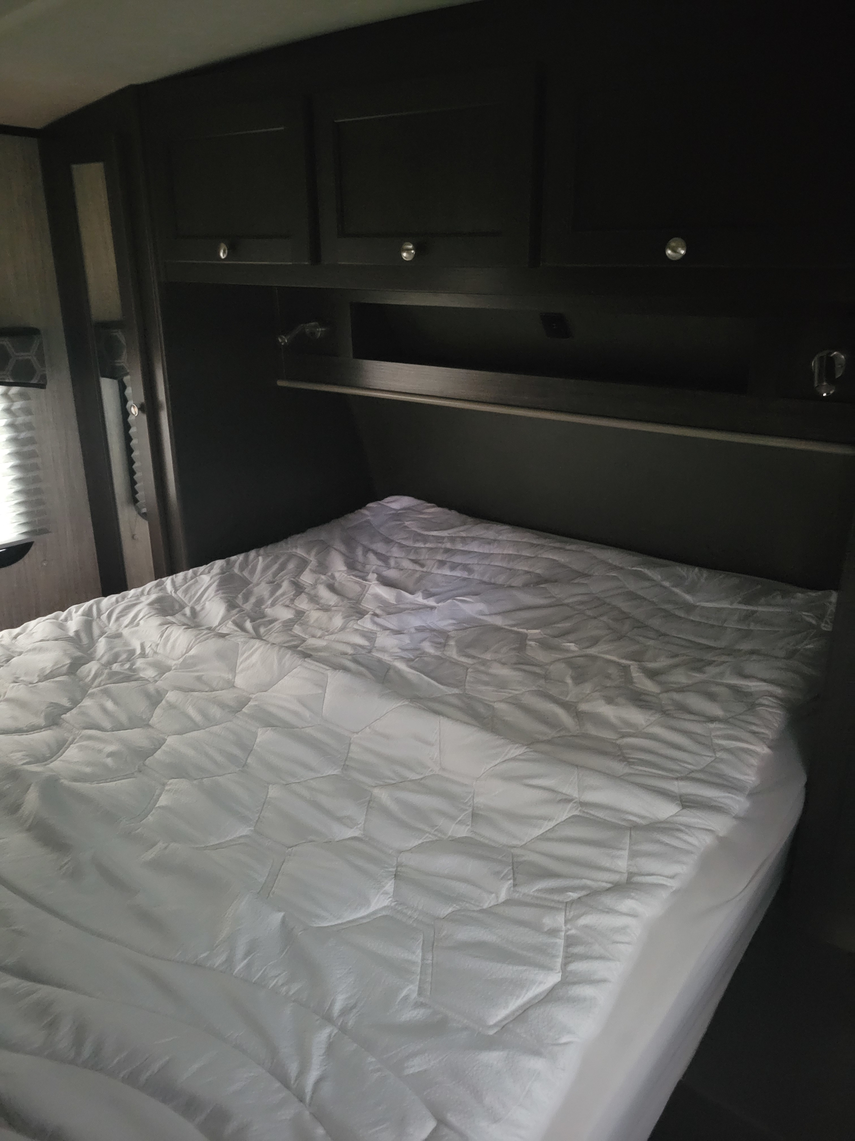 Master bedroom with full size queen sprung mattress. Cruiser RV Shadow Cruiser 2019
