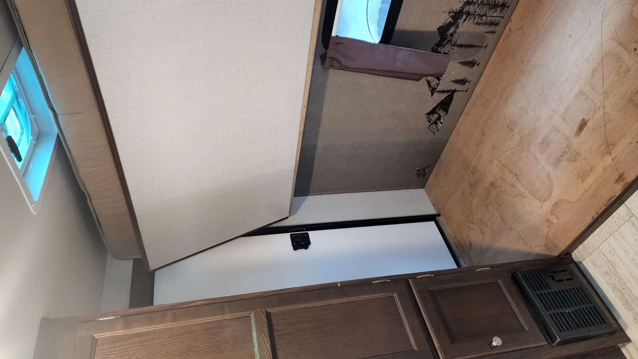 RV rental interior: Bunk/bed area, window, tree-patterned wall, wooden panel, cabinetry, and floor vent.. Palomino Palomini 179BHS 2018