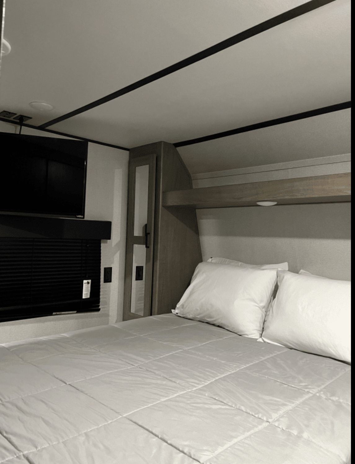 Comfortable RV rental bedroom with a cozy bed, TV, and storage. Perfect for your next adventure.. Keystone RV Hideout 2020