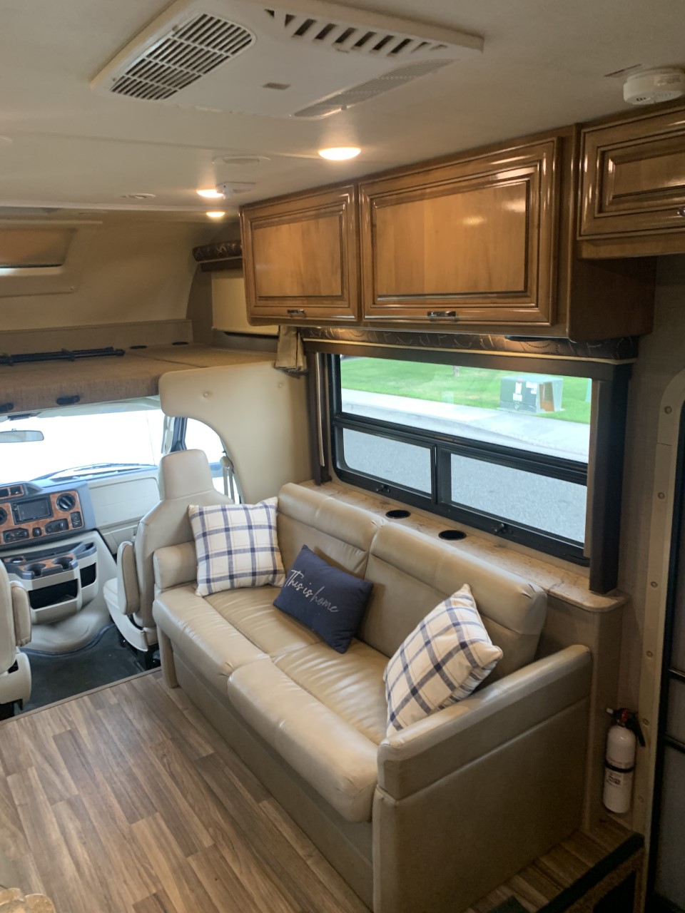 Step into your next adventure! This RV rental offers a cozy interior with a light sofa, wood floors & ample storage.. Thor Quantum 2017