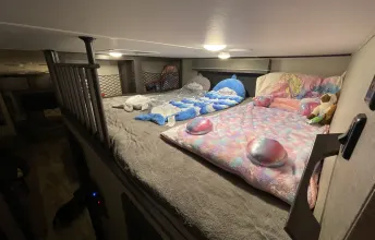 Spacious RV rental bunkhouse: Two cozy beds fill this family-friendly sleeping area, ideal for RV adventures.. Grand Design Reflection 2020