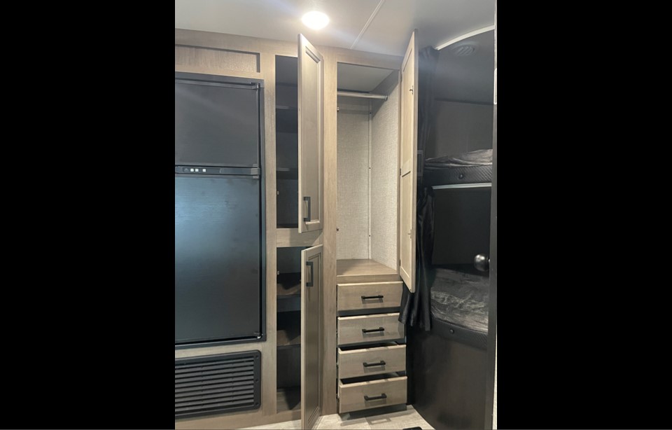 RV rental interior: fridge, pantry, closet with drawers, and bunk beds. Practical storage solutions for your trip.. Jayco Jay Flight 2022