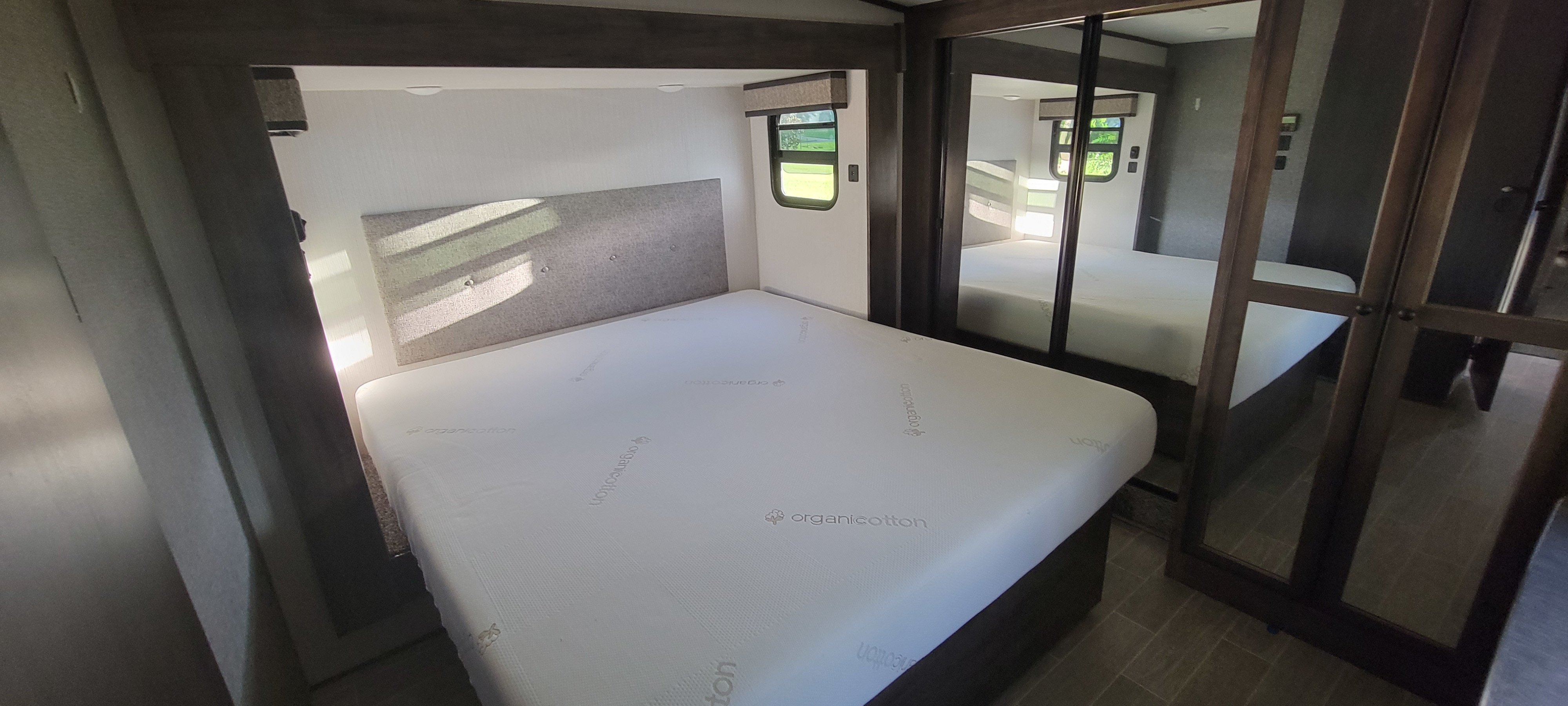 Master bedroom with organic cotton memory foam king size mattress.. Heartland RVs Bighorn Traveler 2021