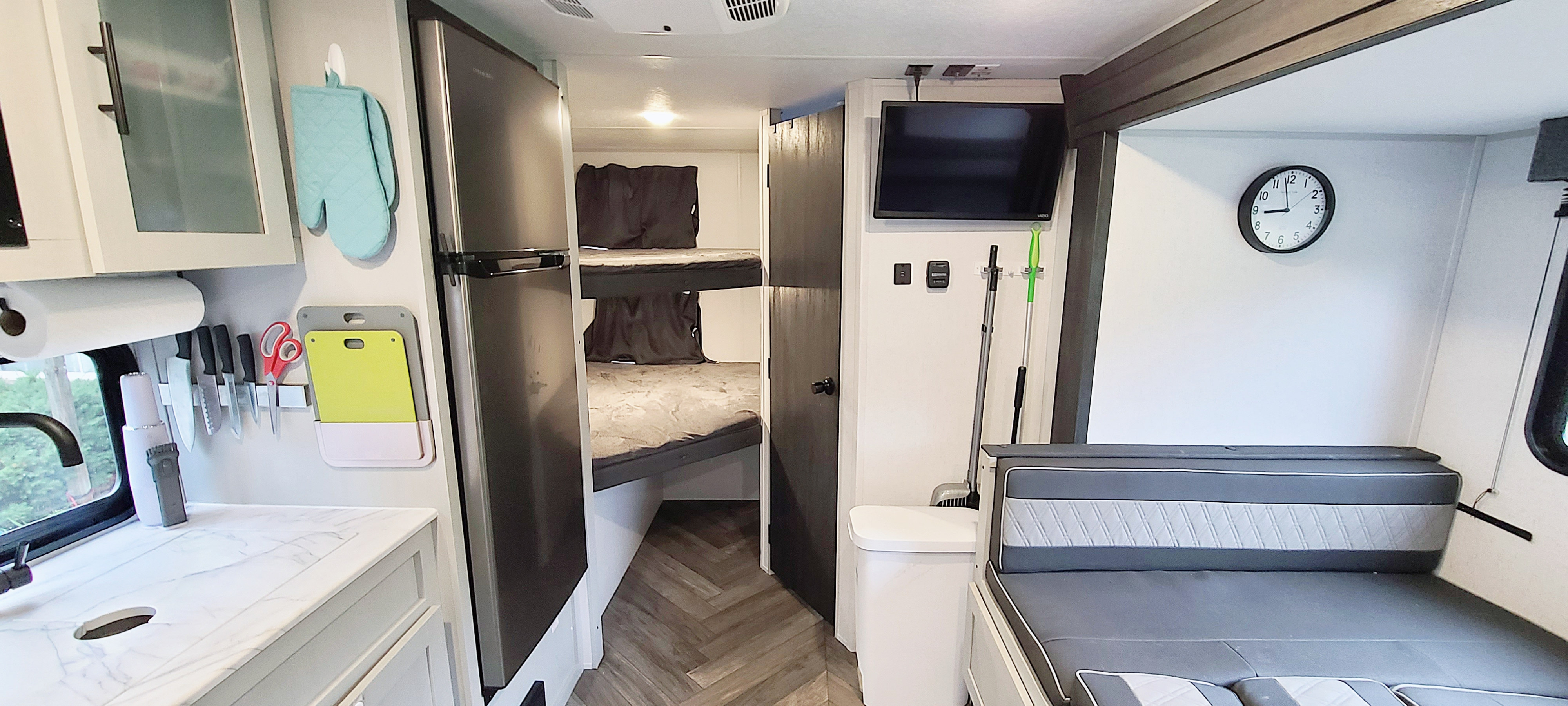Spacious and organized RV rental interior. Features a modern kitchen, bunk beds, and cozy living area, ideal for travel adventures.. Forest River Salem FSX Platinum 2022