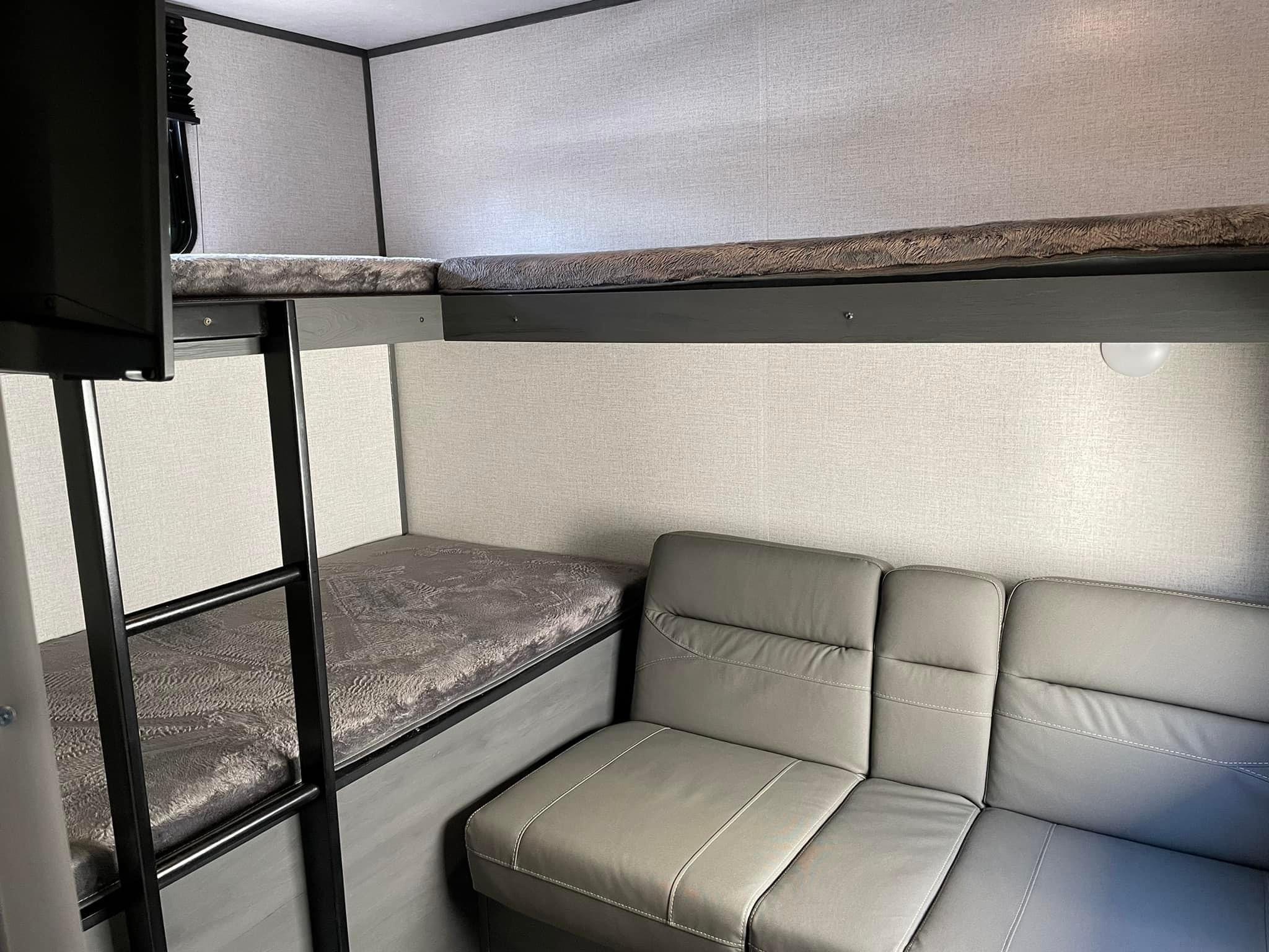 RV rental: Modern gray interior with bunk beds, a ladder, and a comfortable sofa for travel.. Dutchmen Aspen Trail 3280BHS 2021