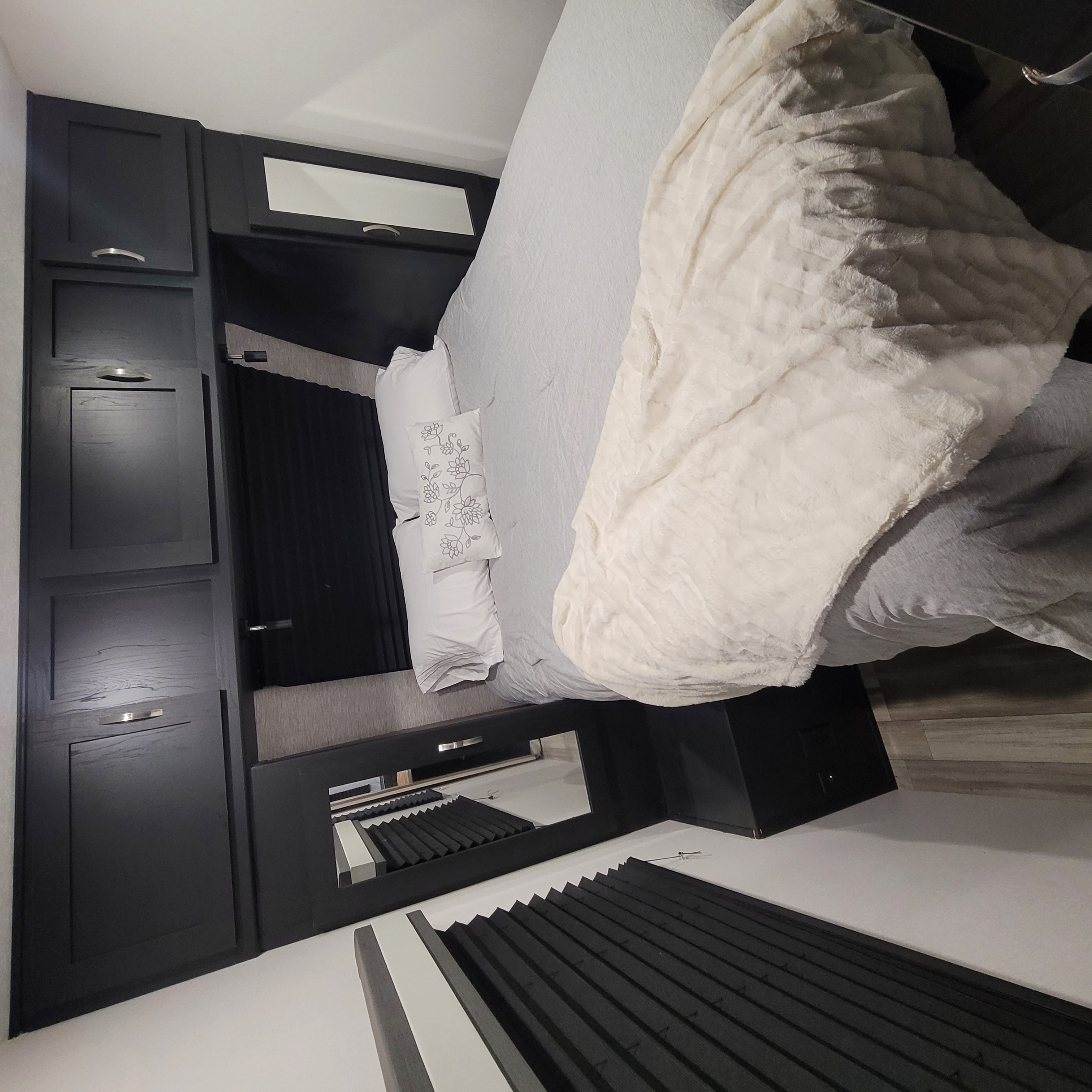 RV rental: A modern bedroom with dark built-in storage, a comfortable bed with soft blankets, and practical window blinds.. Forest River Coachmen Freedom Express Ultra Lite 2022