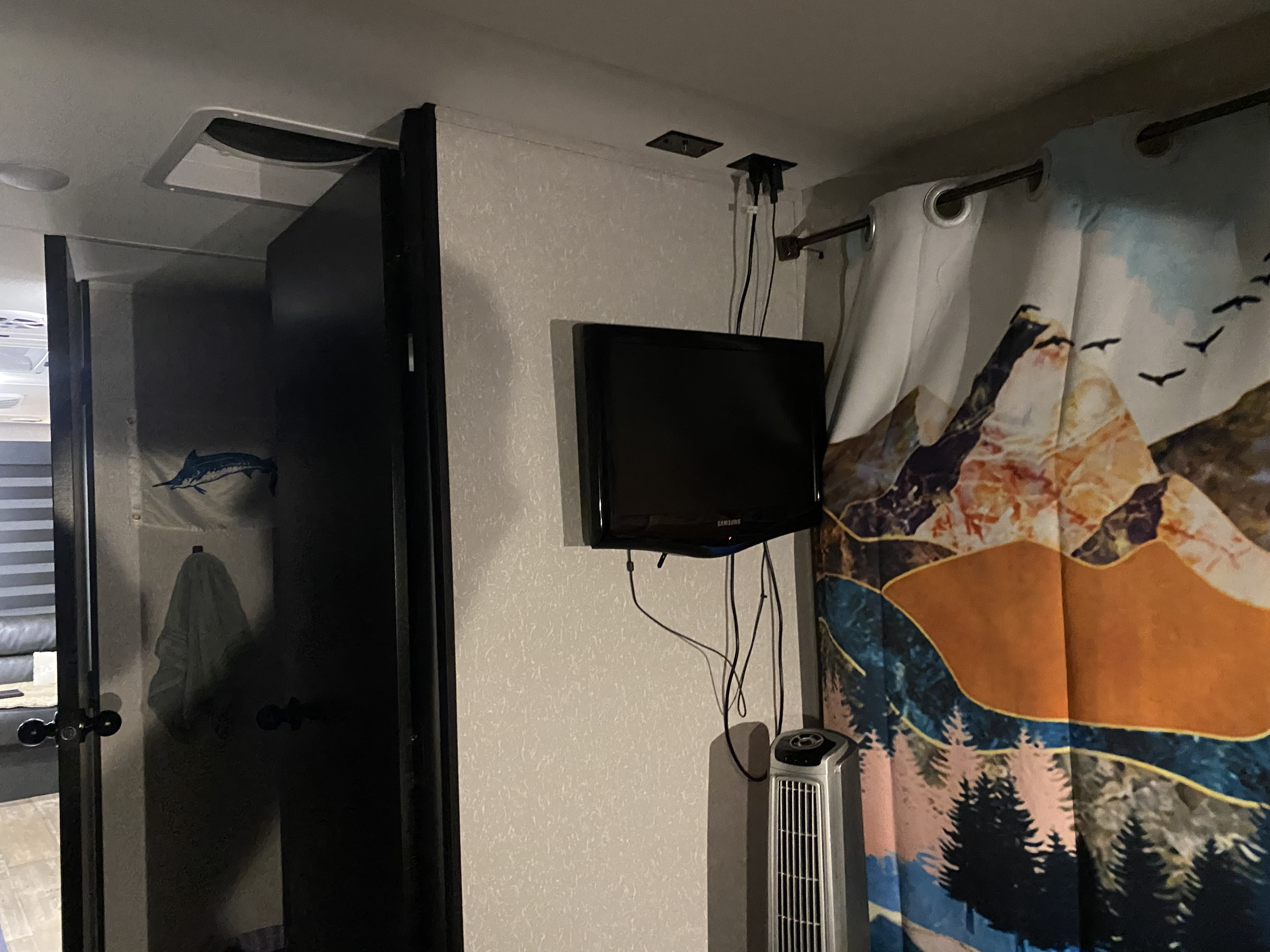 Small TV located in bedroom for movie night. Forest River Cherokee Grey Wolf Black Label 2022