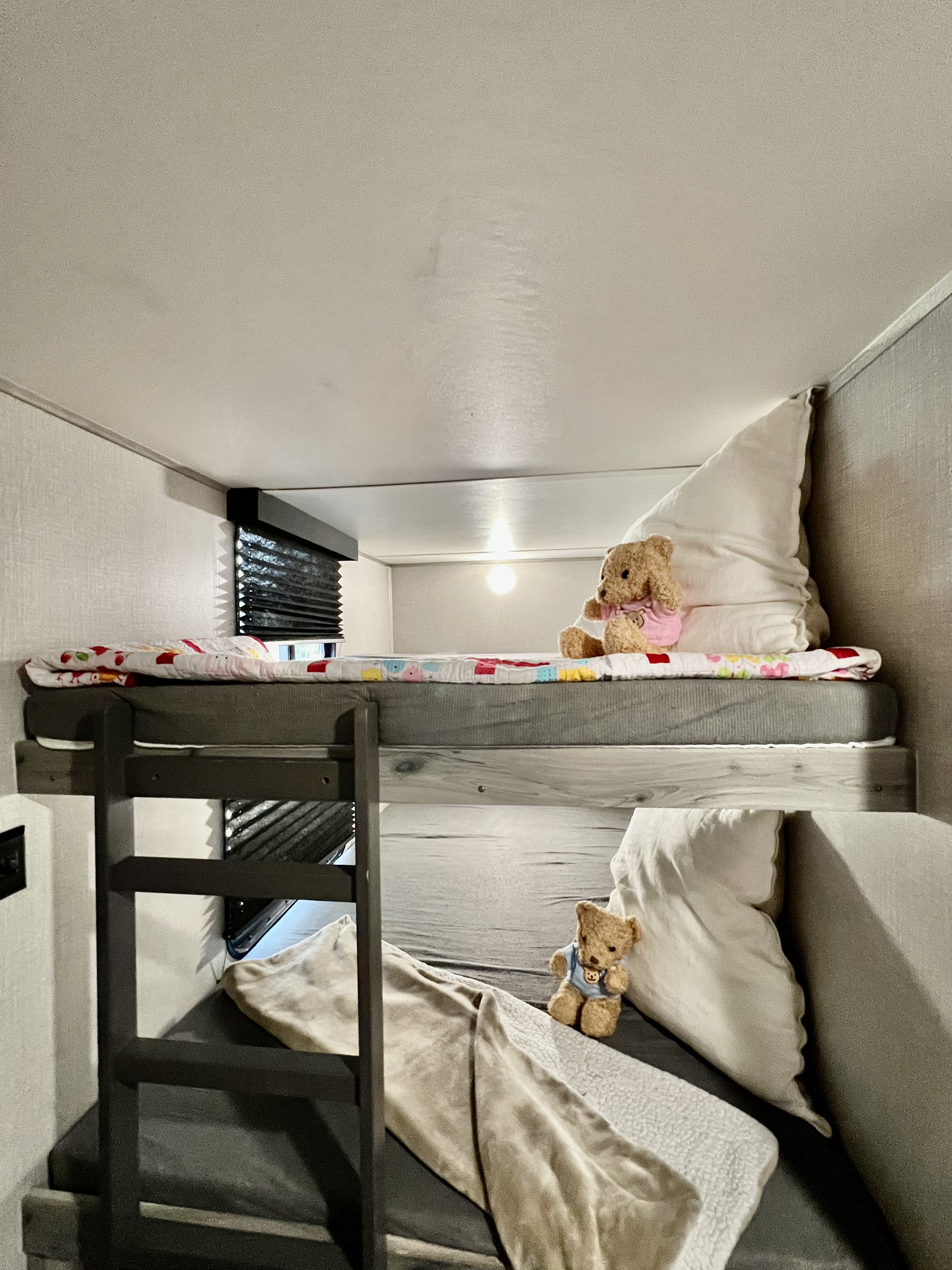 RV rental interior: Cozy bunk beds with a ladder, soft bedding, and teddy bears for a comfortable family trip.. Dream 290DBS 2022