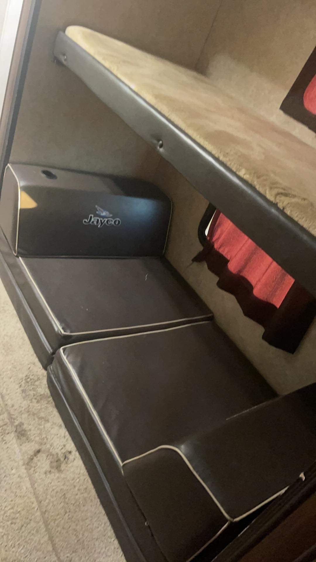 RV rental: Jayco bunk bed setup with dark brown cushions below and a red curtain in the bunk area.. Jayco Jay Flight 2016