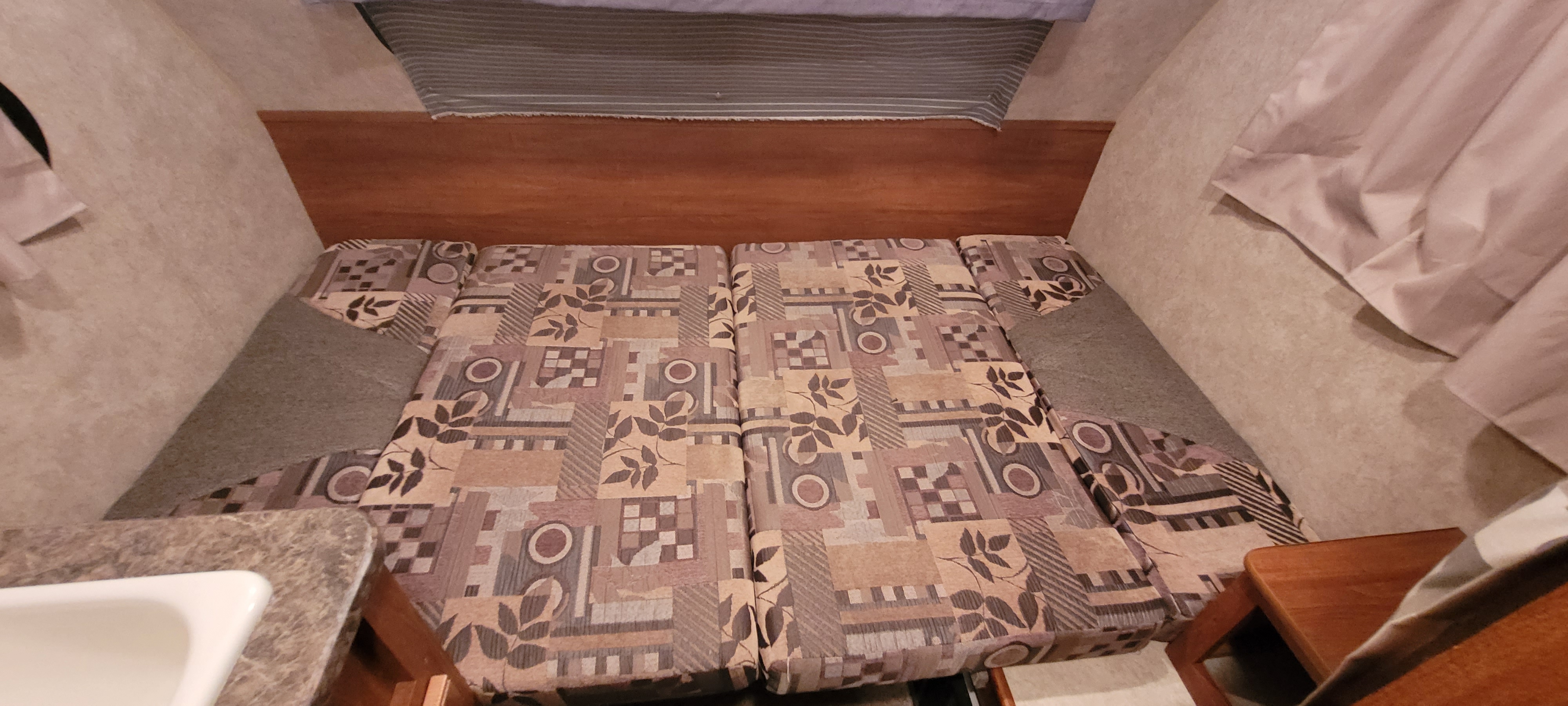 Dinette area with the table converted into the bed.. Forest River R-Pod 152 2009