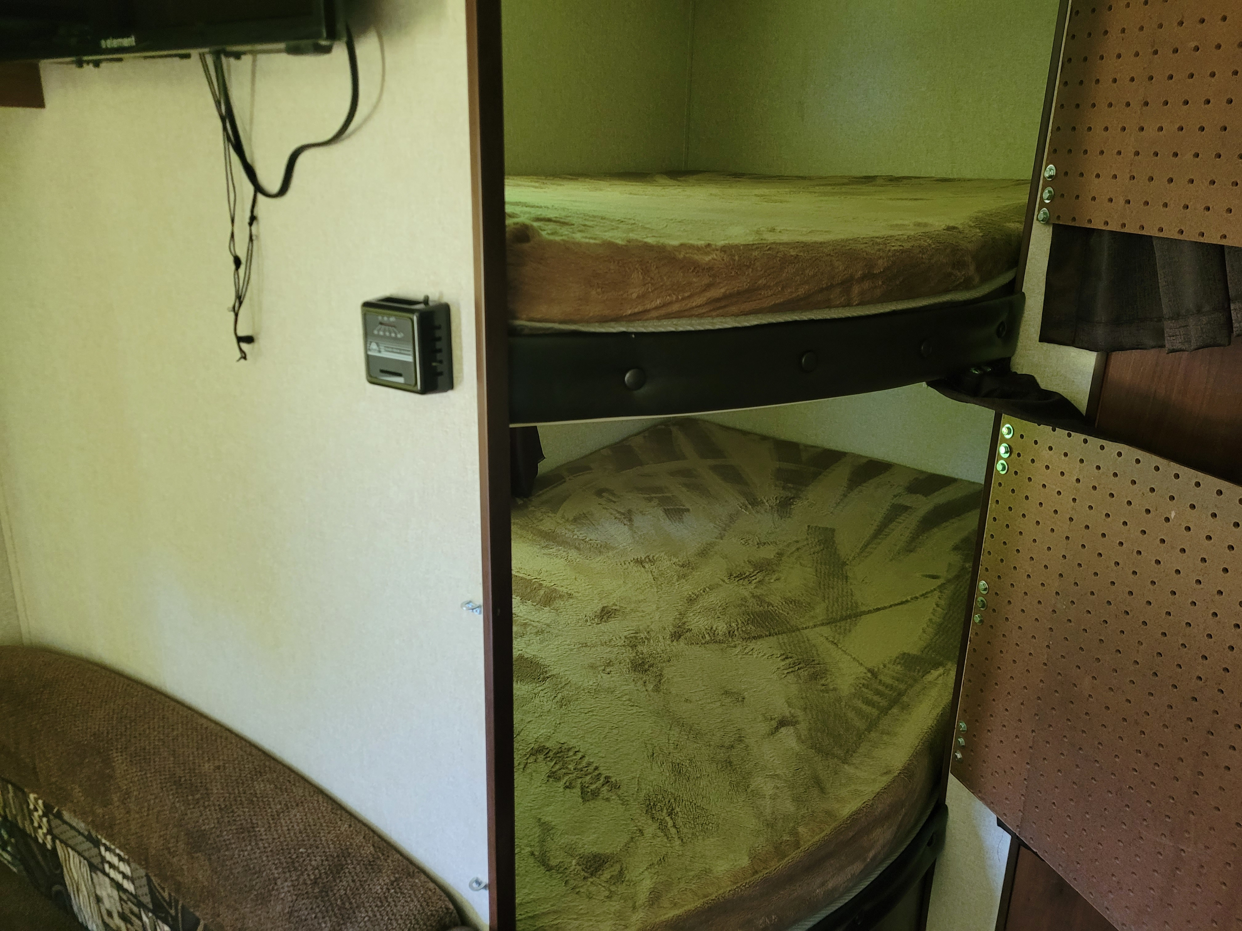 RV rental interior featuring cozy bunk beds and a compact sleeping area with a couch. Perfect for travelers.. Jayco Jay Flight SLX 2017