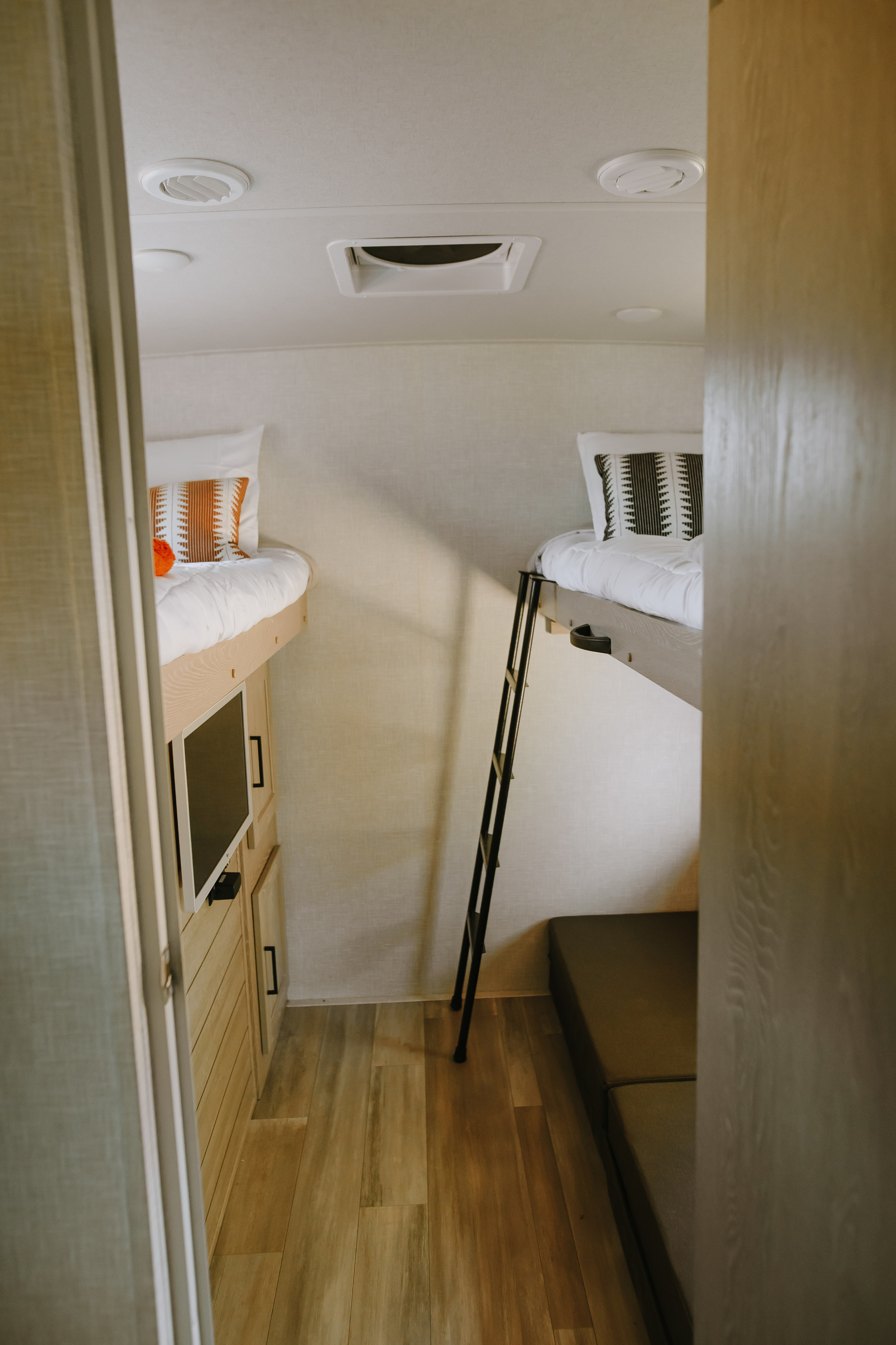 Cozy RV rental interior with bunk beds, a TV, and a sofa, perfect for family adventures.. Forest River Rockwood Ultra Lite 2021