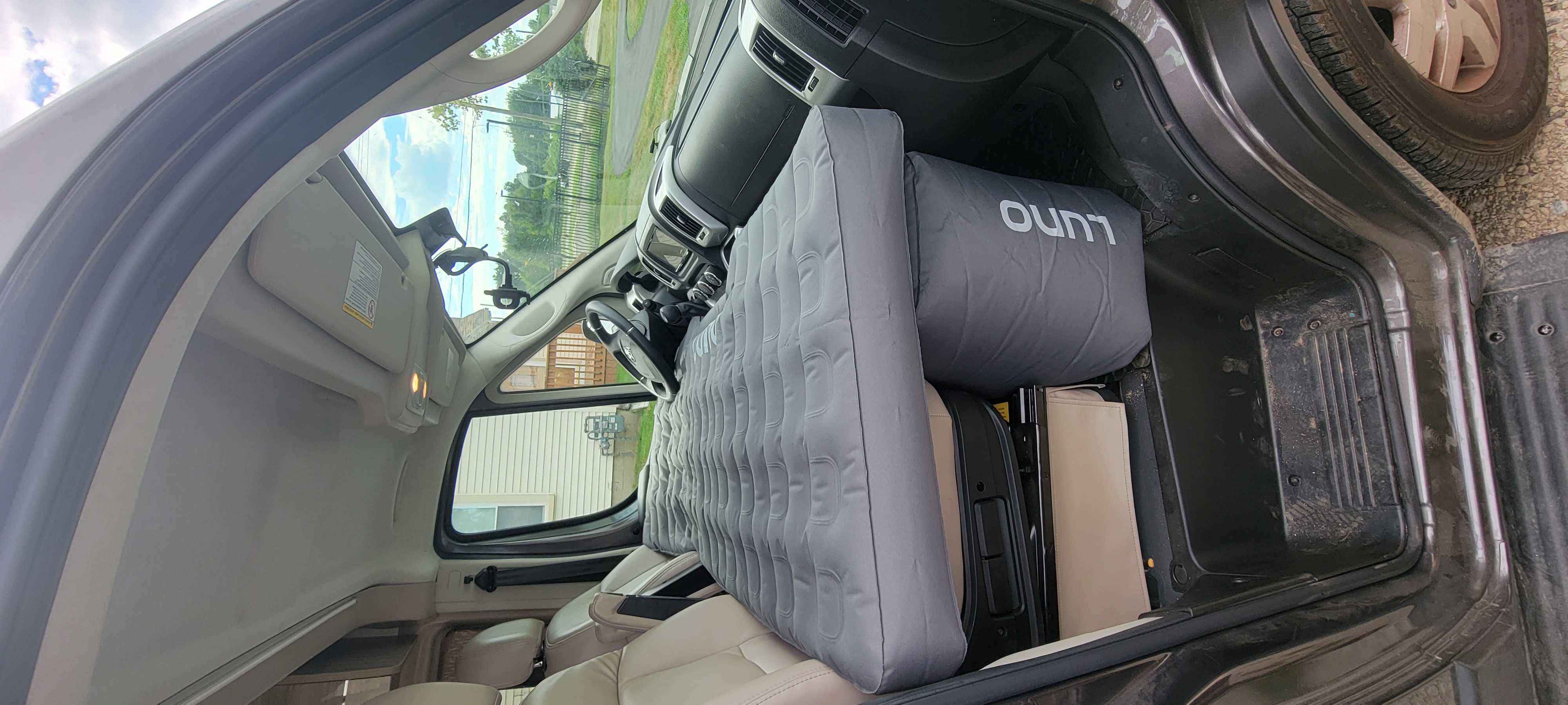 Inside a spacious van, a grey Luno air mattress transforms the area into a comfy bed for your rv rental trip.. Thor Scope 2022