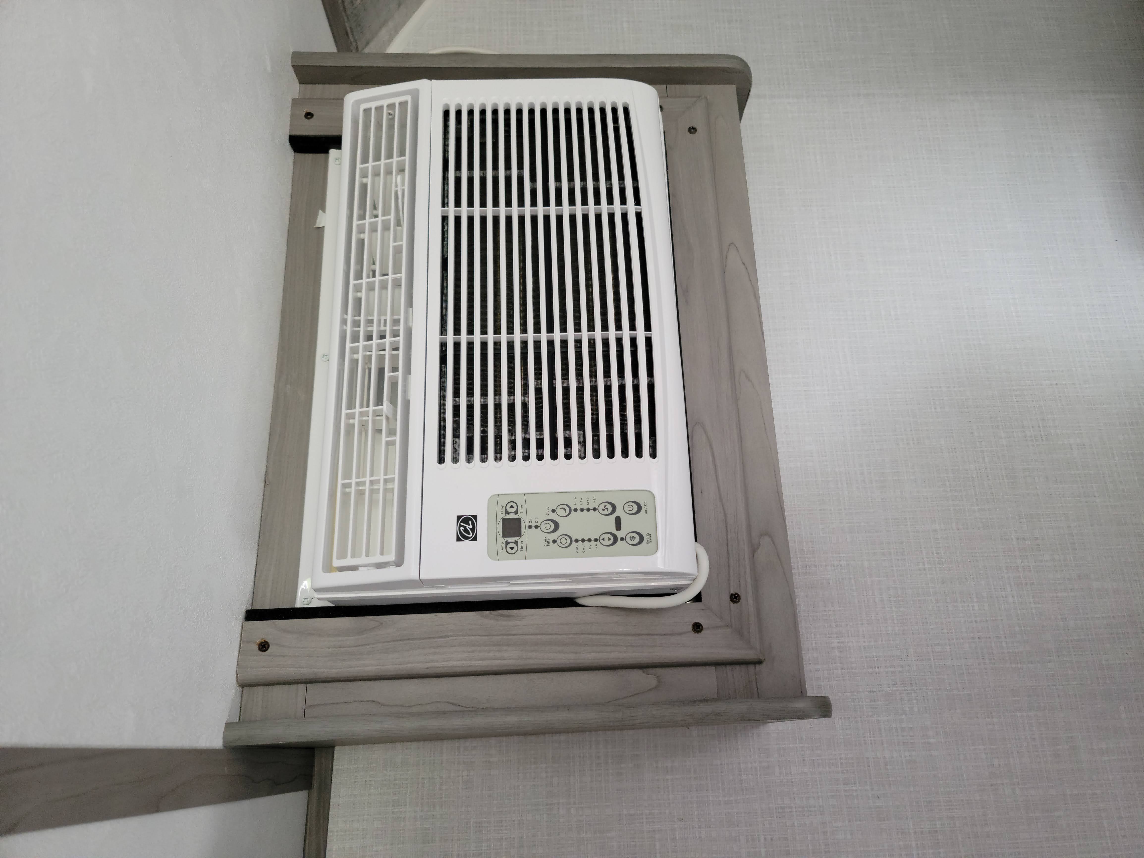 RV rental interior showing a white, wall-mounted air conditioner unit for climate control, ensuring comfort on the road.. Dutchmen Coleman Lantern LT 2022