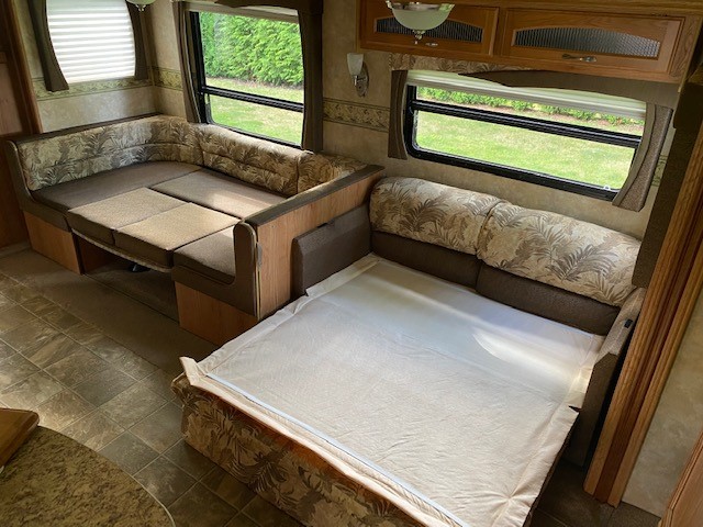 RV rental interior: dinette converts to bed (left), sofa pulls out to bed (right). Compact and ready for comfortable sleep.. Jayco Jay Flight 2009