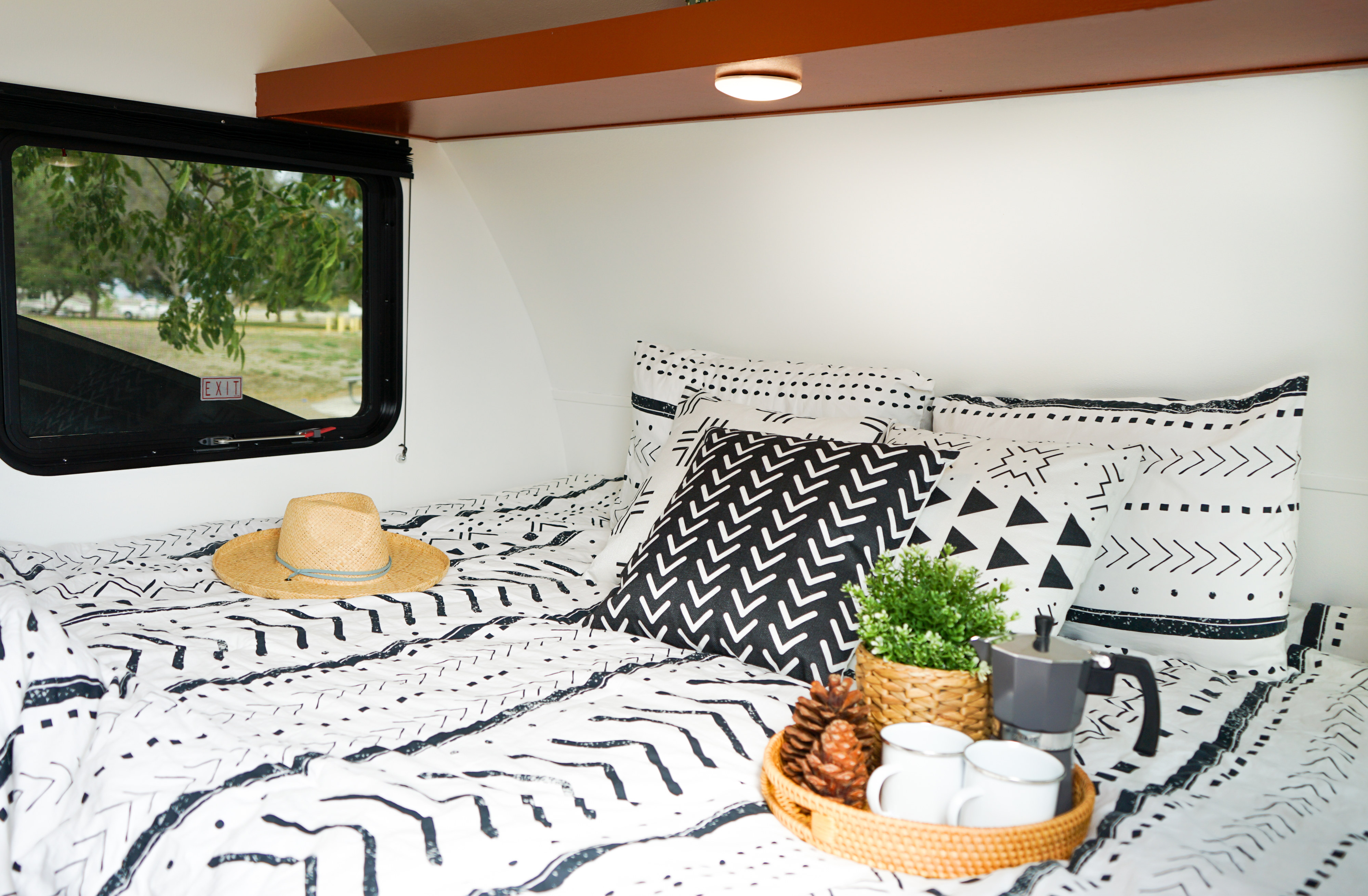 Wake up refreshed in your RV rental! A cozy bed with bohemian patterns, coffee, and scenic views await.. Forest River Sonoma 1670BH 2020